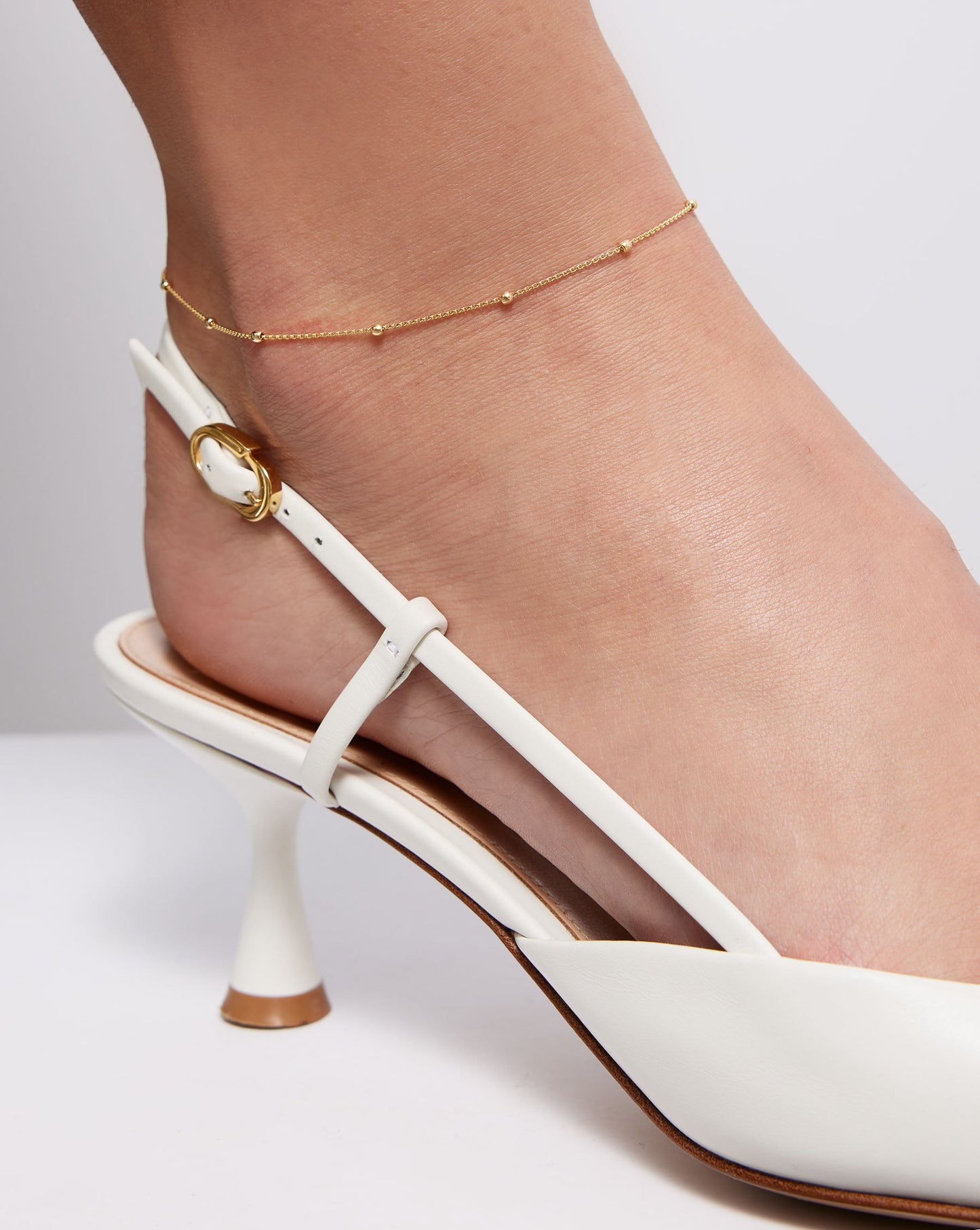 Saturn Chain Anklet on model wearing white sling back sandal