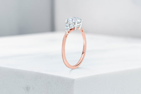 Tribeca VOW by Ring Concierge round with trio side stones engagement ring in rose gold. 33281407647832
