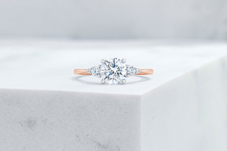 Waverly VOW by Ring Concierge round with pear illusion side stones engagement ring in rose gold. 33281406697560