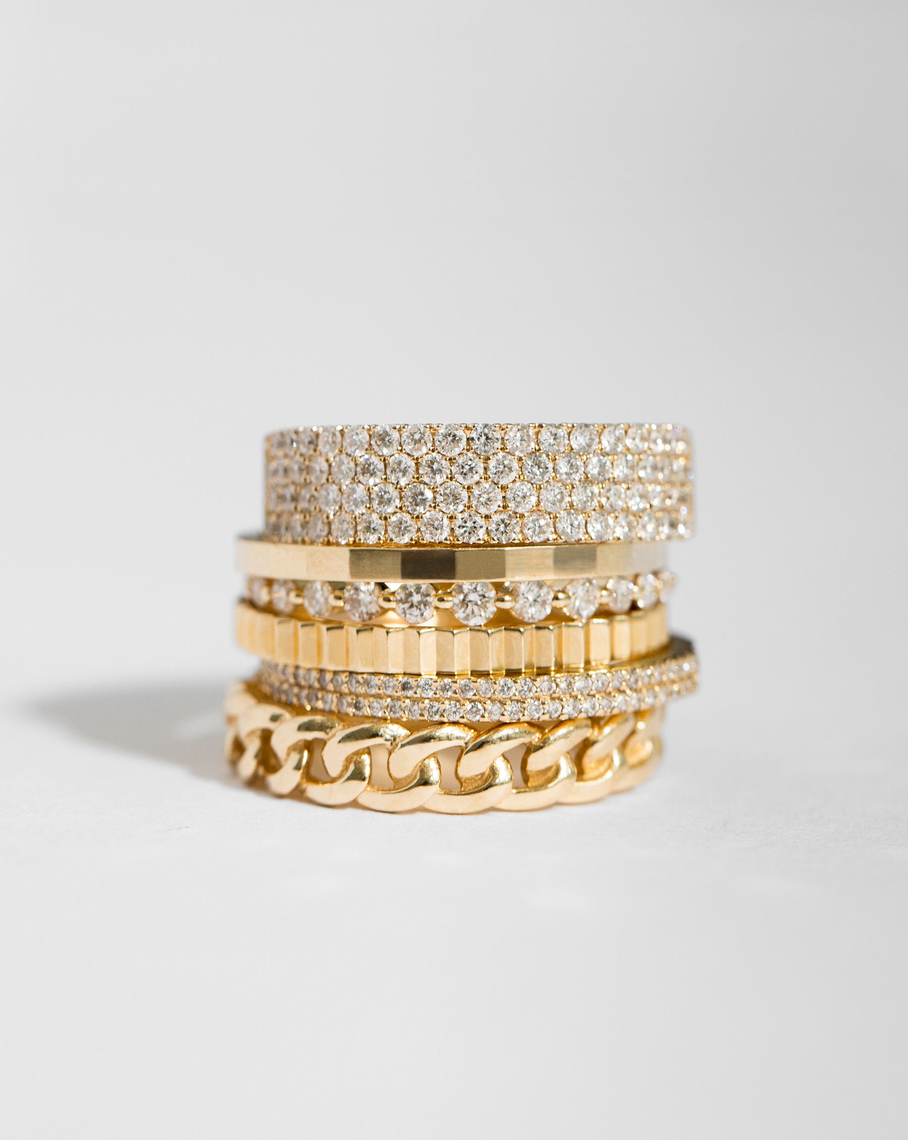 stack of 6 Ring Concierge gold and diamond rings