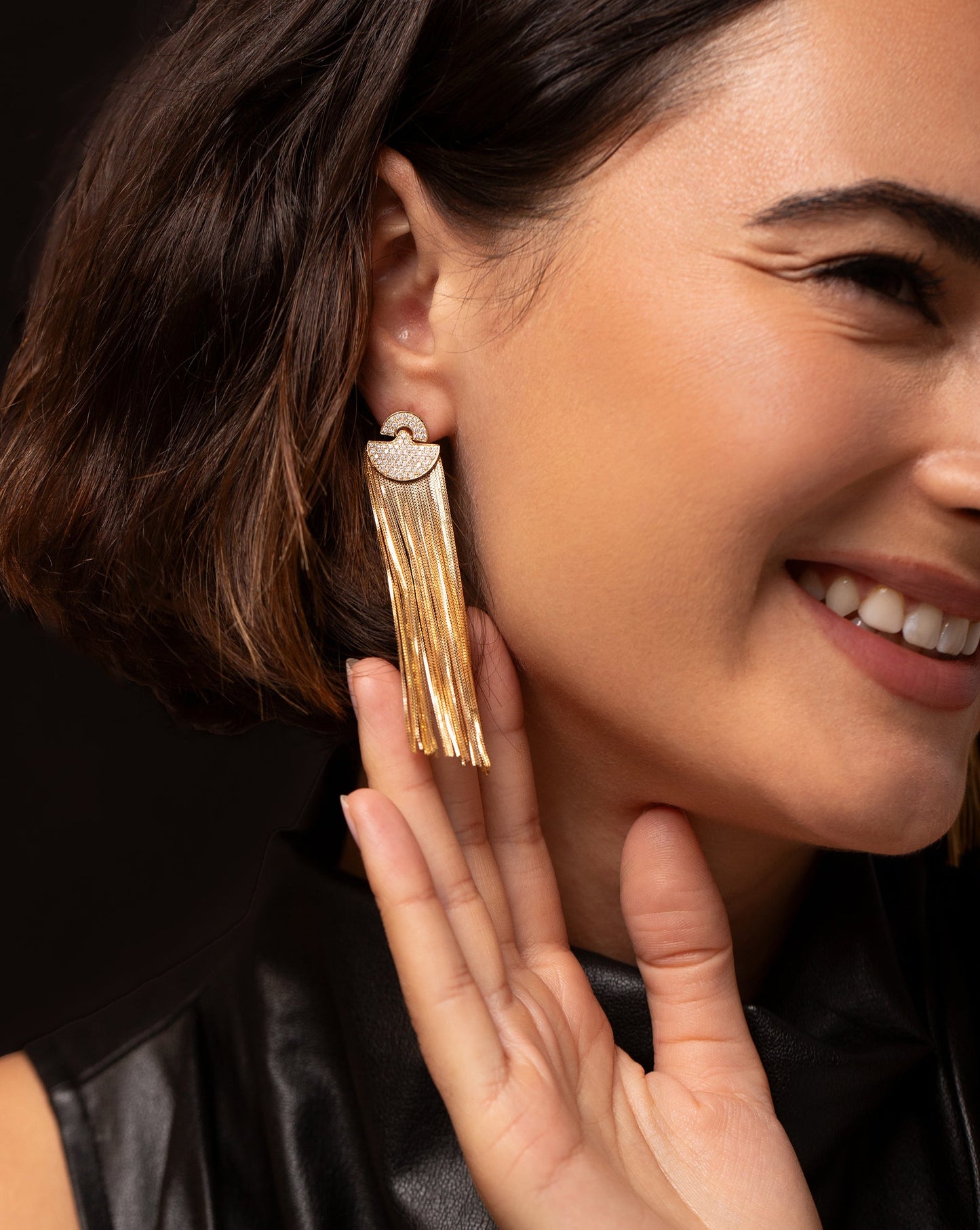 Art Deco Waterfall Earrings in ear of model being touched by her hand