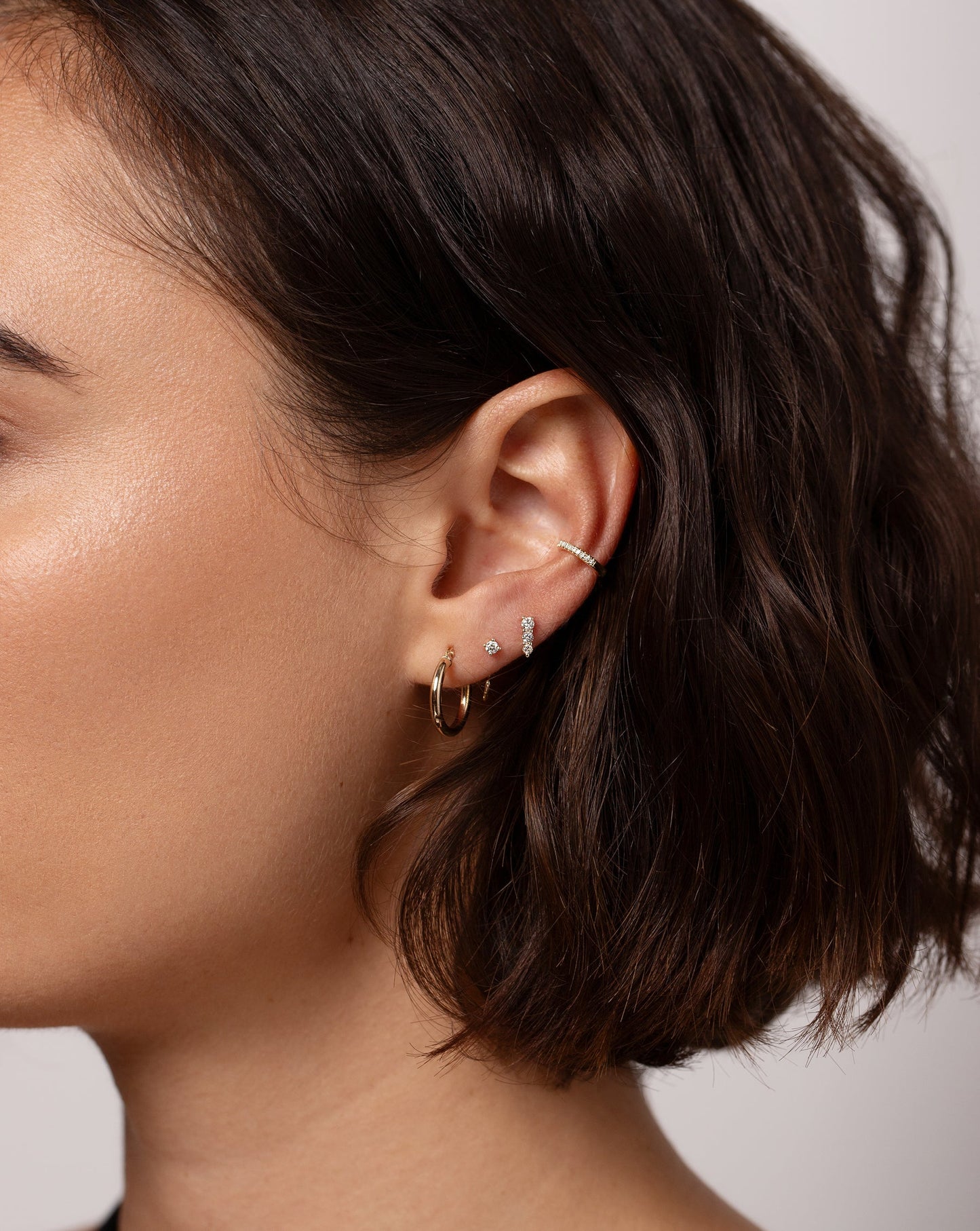 Mini Diamond Ear Cuff on model styled with 3 other Ring Concierge earrings