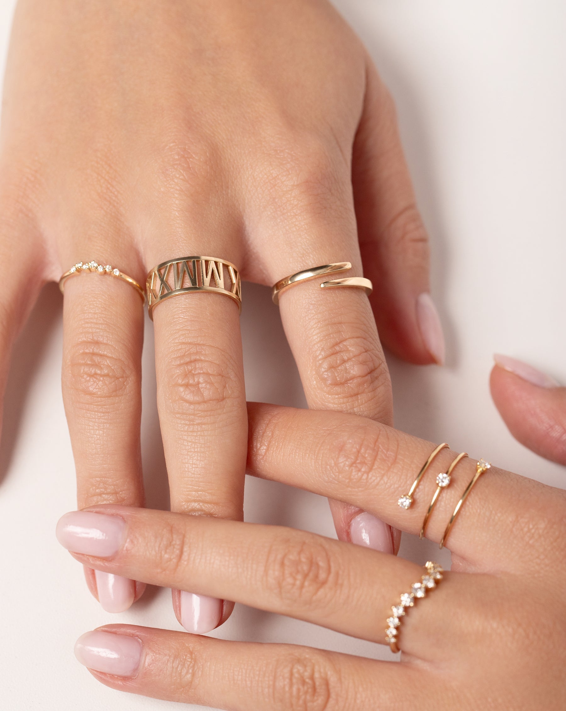 Model wearing 5 Ring Concierge gold and diamond rings