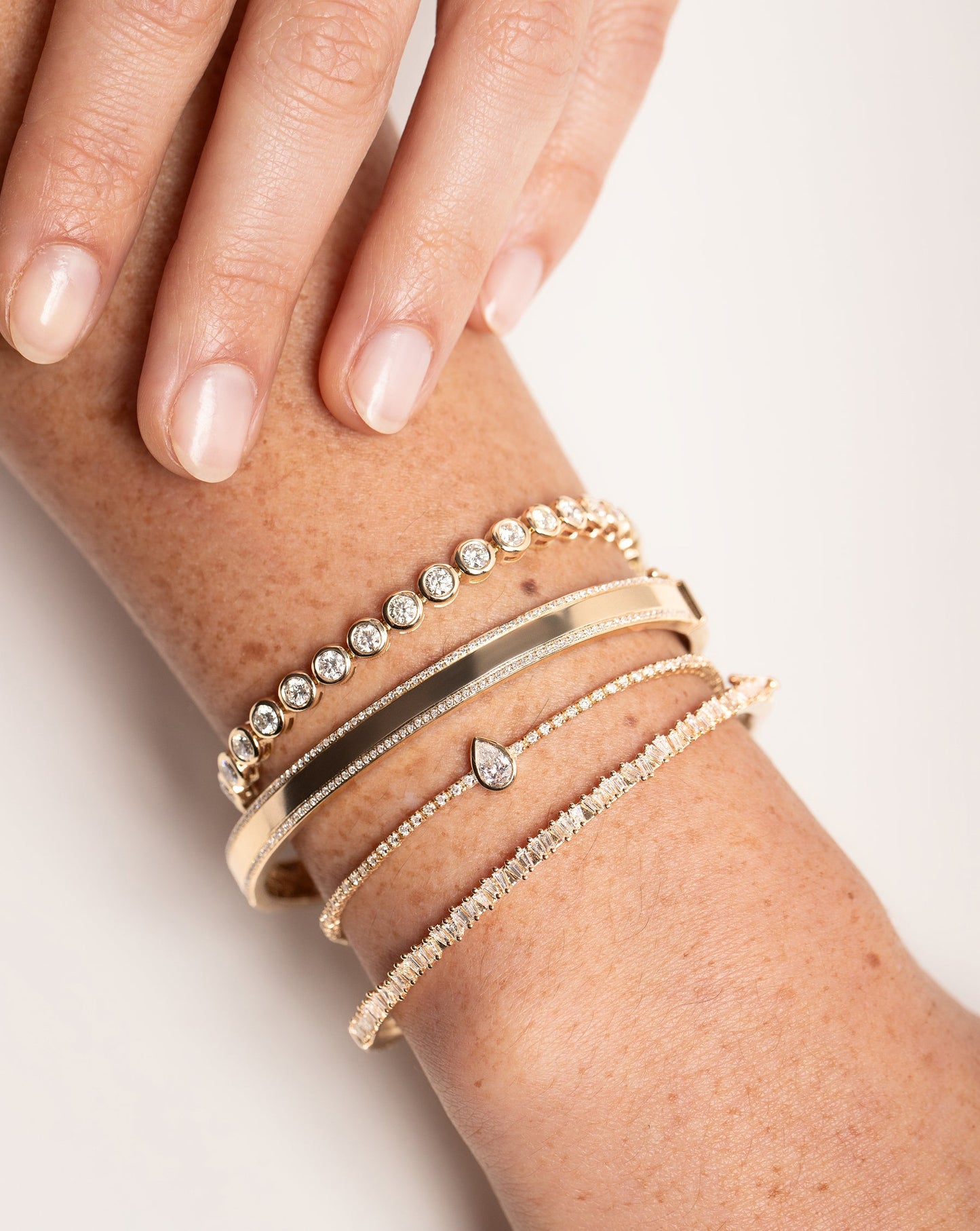 Diamond Border Bangle styled with 3 other bracelets