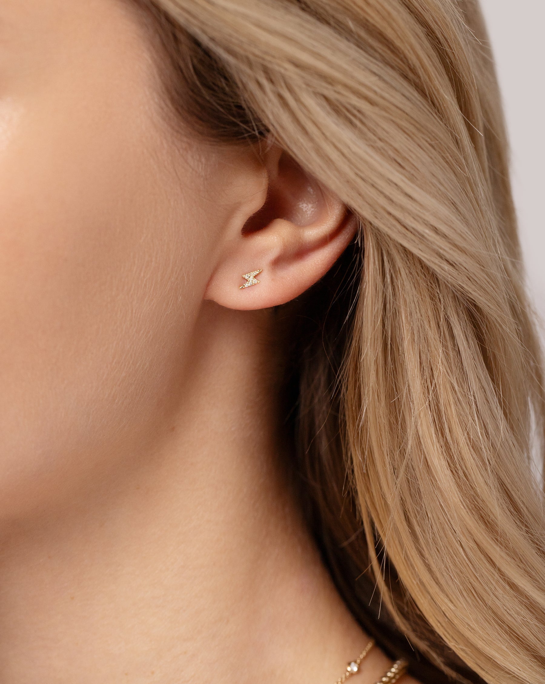 Mini Lightning Bolt Studs shown on ear of model