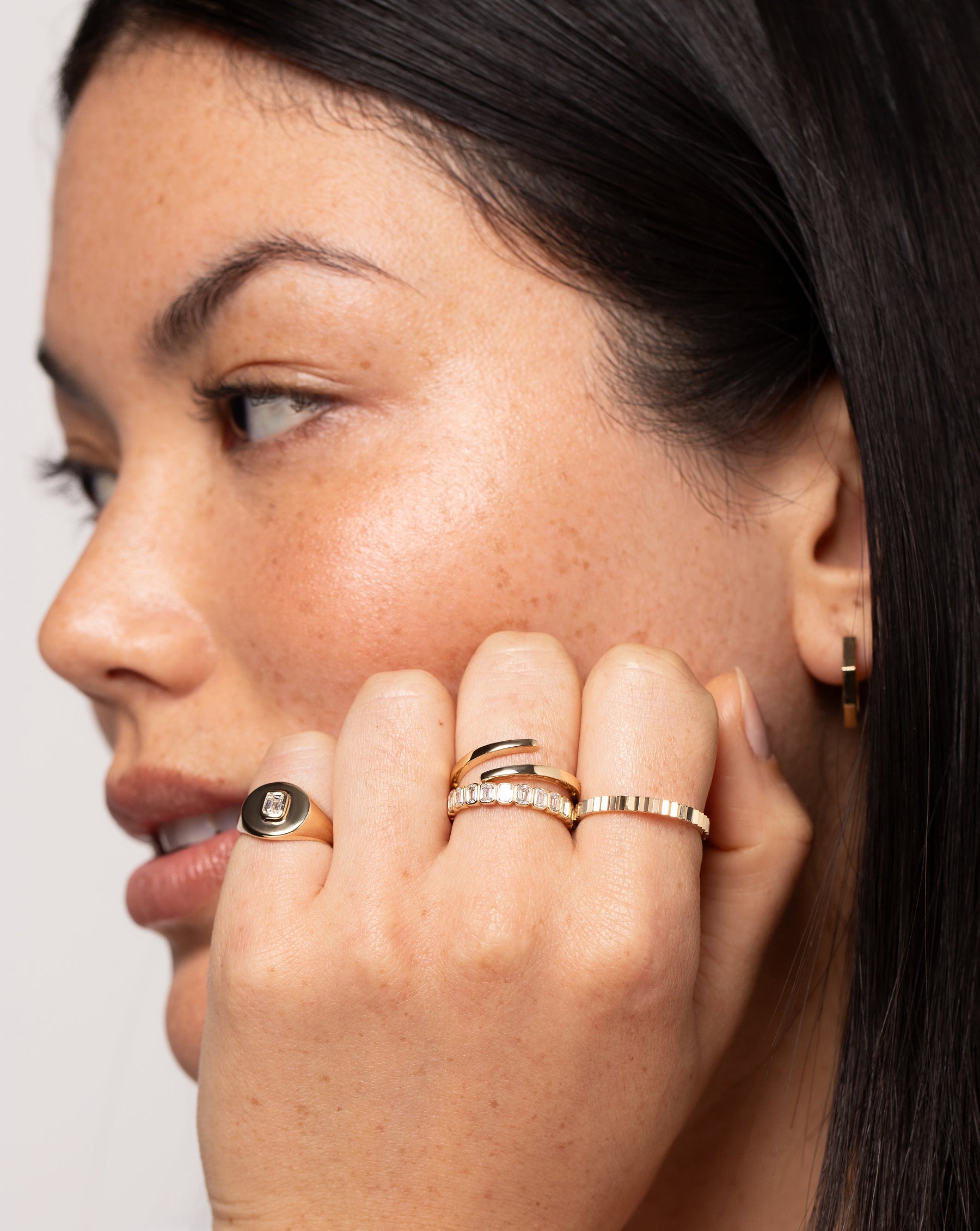 Model wearing 4 Ring Concierge gold and diamond rings