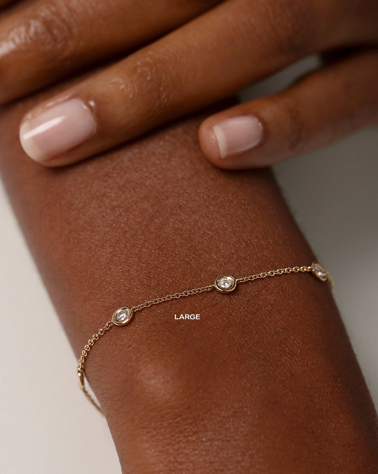 large bezel-set round diamond station bracelet on model