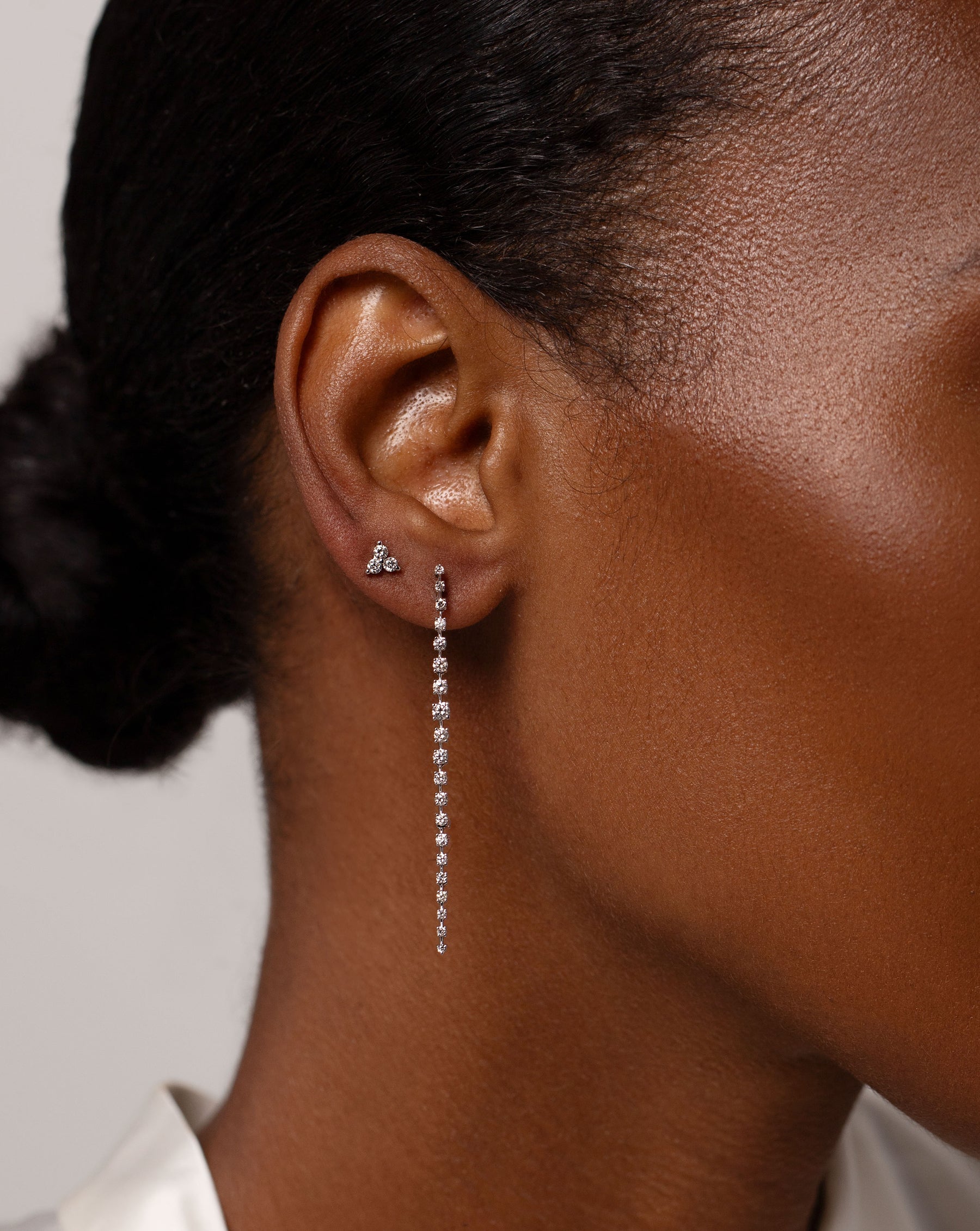 Diamond Trio Stud worn on ear with the Graduated Diamond Drop Earrings