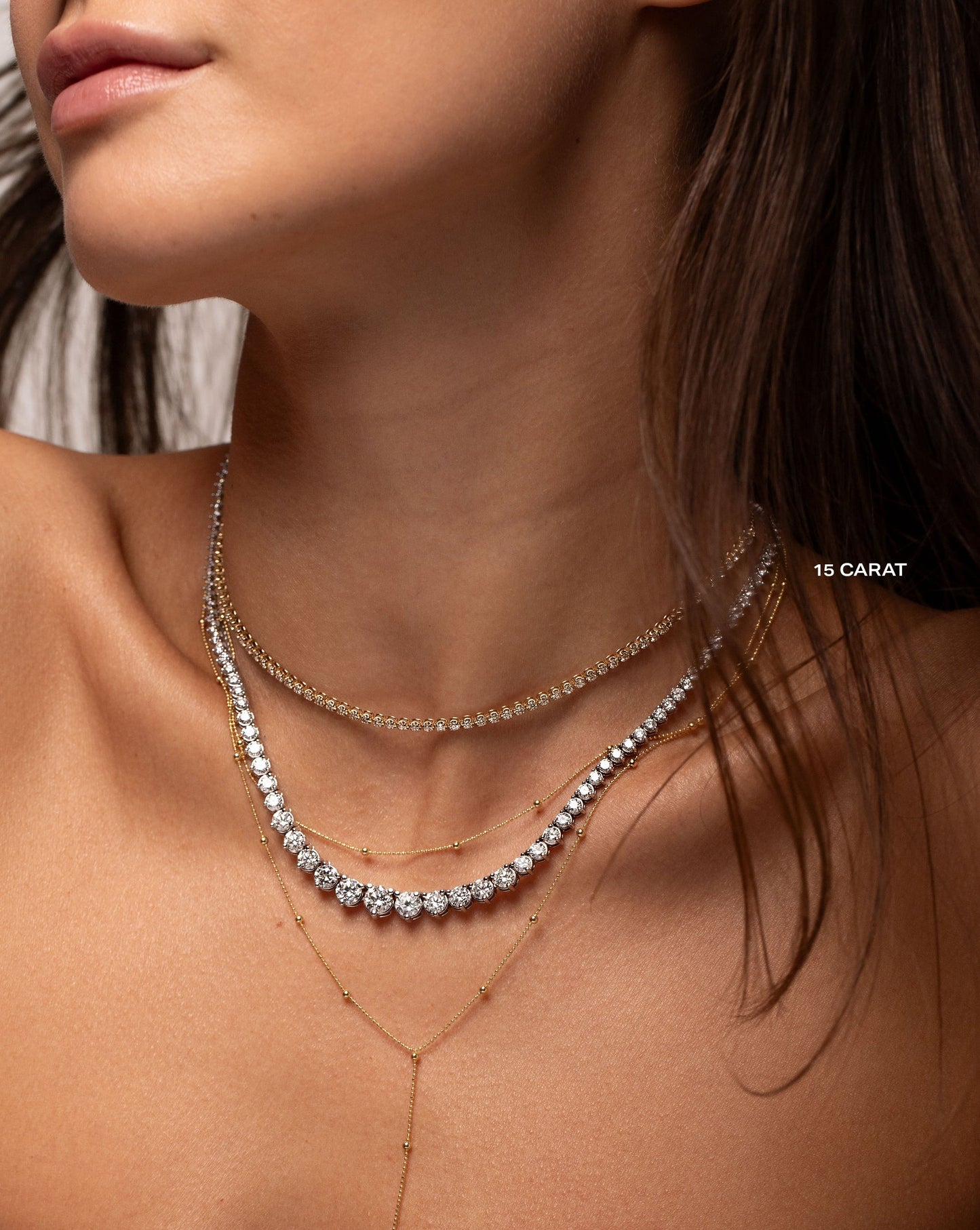 Graduated Diamond Tennis Necklace styled on neck with two other necklaces