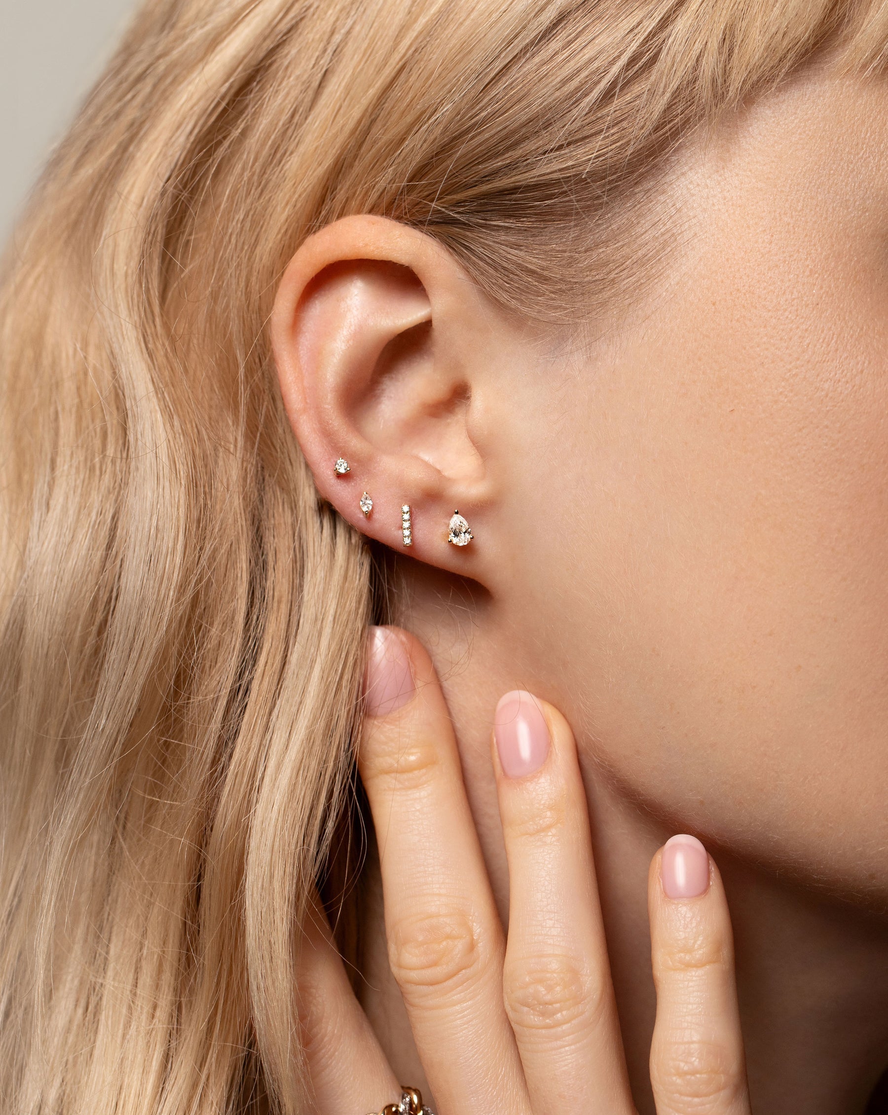  Tiny Diamond Stud stacked with the Tiny Marquise Diamond Stud, Petite Line Diamond Stud and pear shaped Half Carat Mixed Shaped Studs