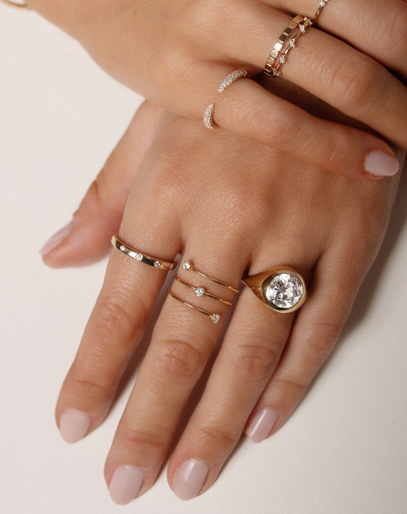 Model wearing Inlay Diamond Ring, Floating Diamond Wrap Ring, Geometric Stackable Ring, Triple Row Diamond Claw Ring, Baguette Distance Ring, Scattered Diamond Stackable Ring and an Oculos engagement ring  