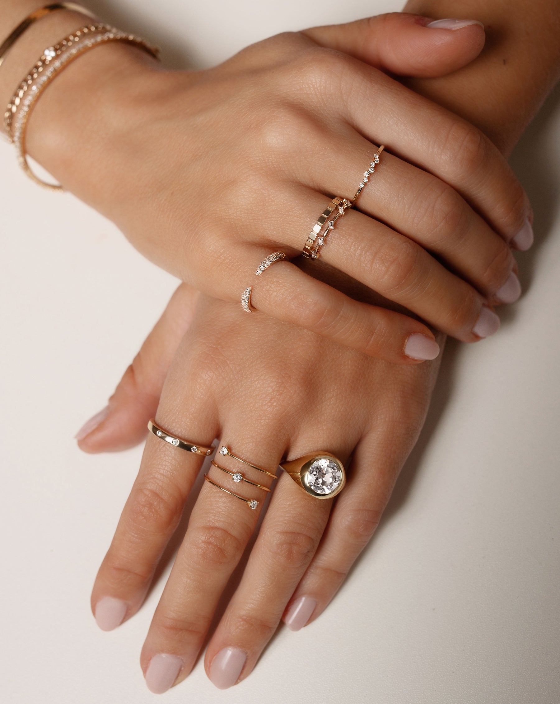 Model wearing Inlay Diamond Ring, Floating Diamond Wrap Ring, Geometric Stackable Ring, Triple Row Diamond Claw Ring, Baguette Distance Ring, Scattered Diamond Stackable Ring and an Oculos engagement ring