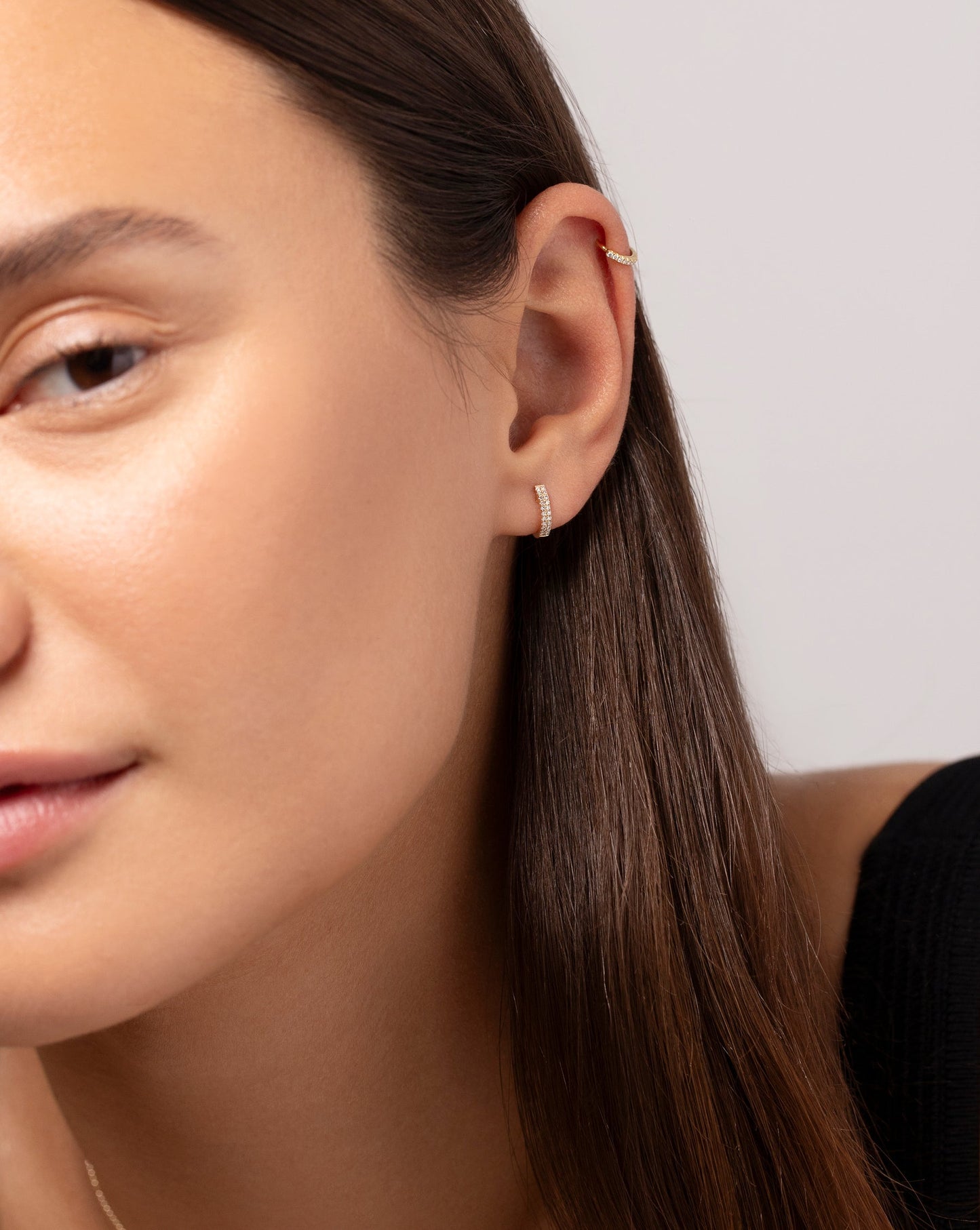Petite Double Row Huggies and the Mini Diamond Ear Cuff shown in ear of model