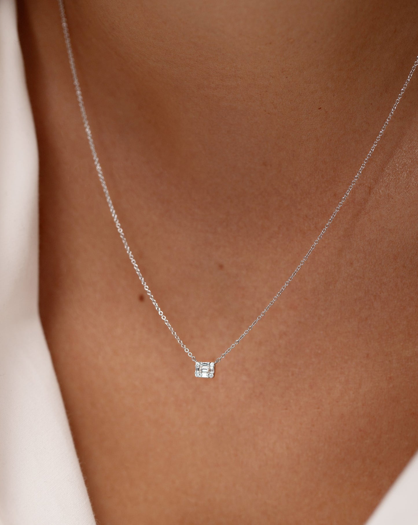 Petite Emerald Illusion Necklace shown close up on neck of model