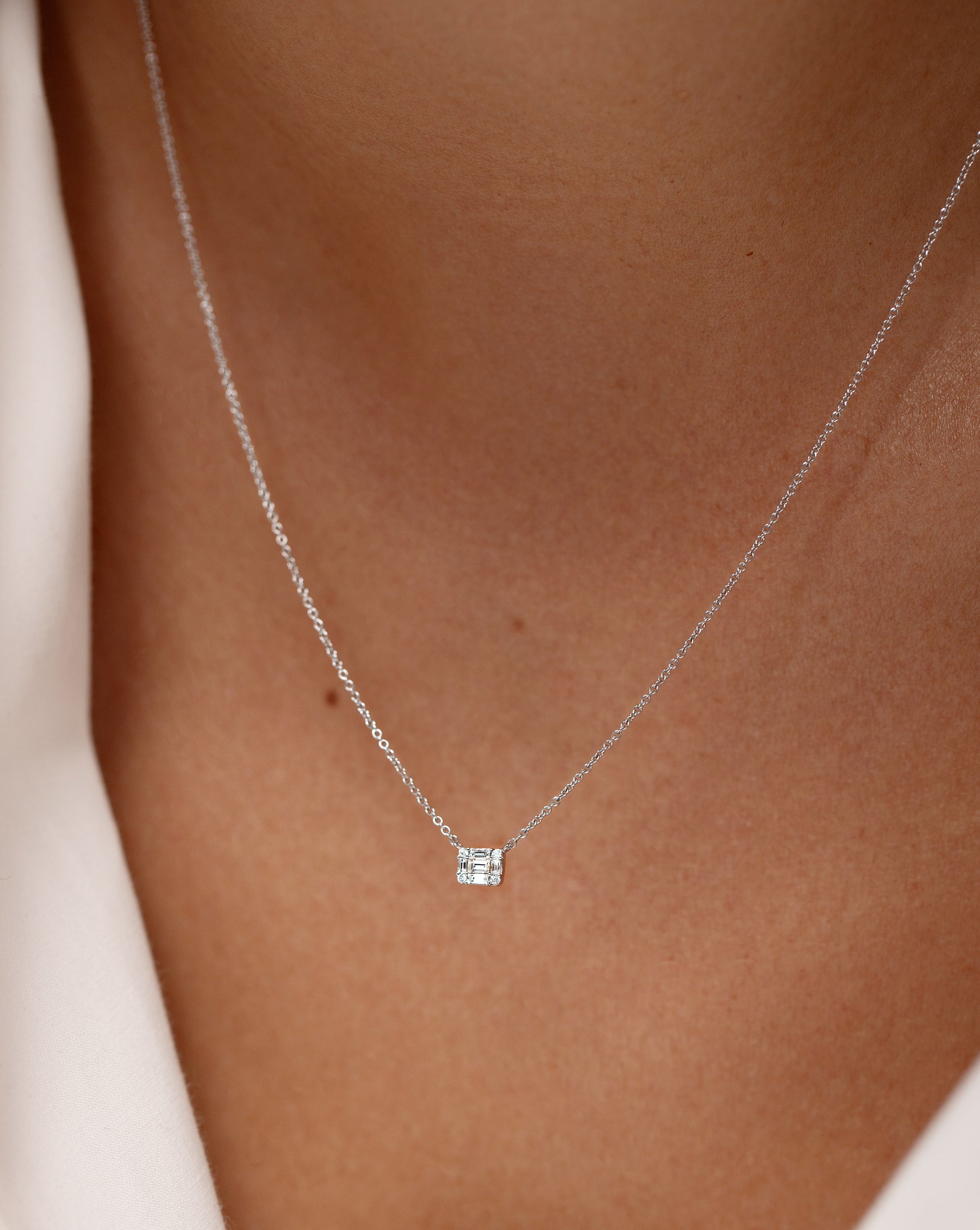 Petite Emerald Illusion Necklace shown close up on neck of model