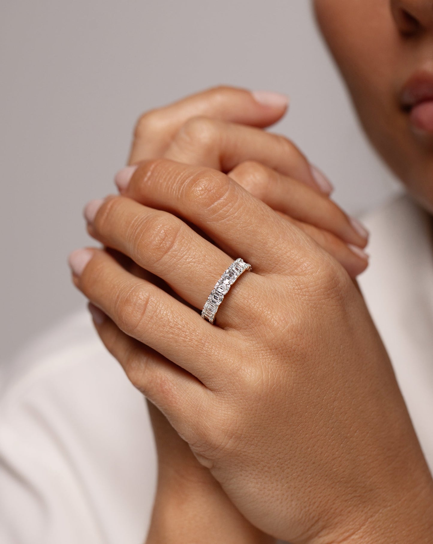 Petite Emerald Illusion Ring shown on middle finger of hand