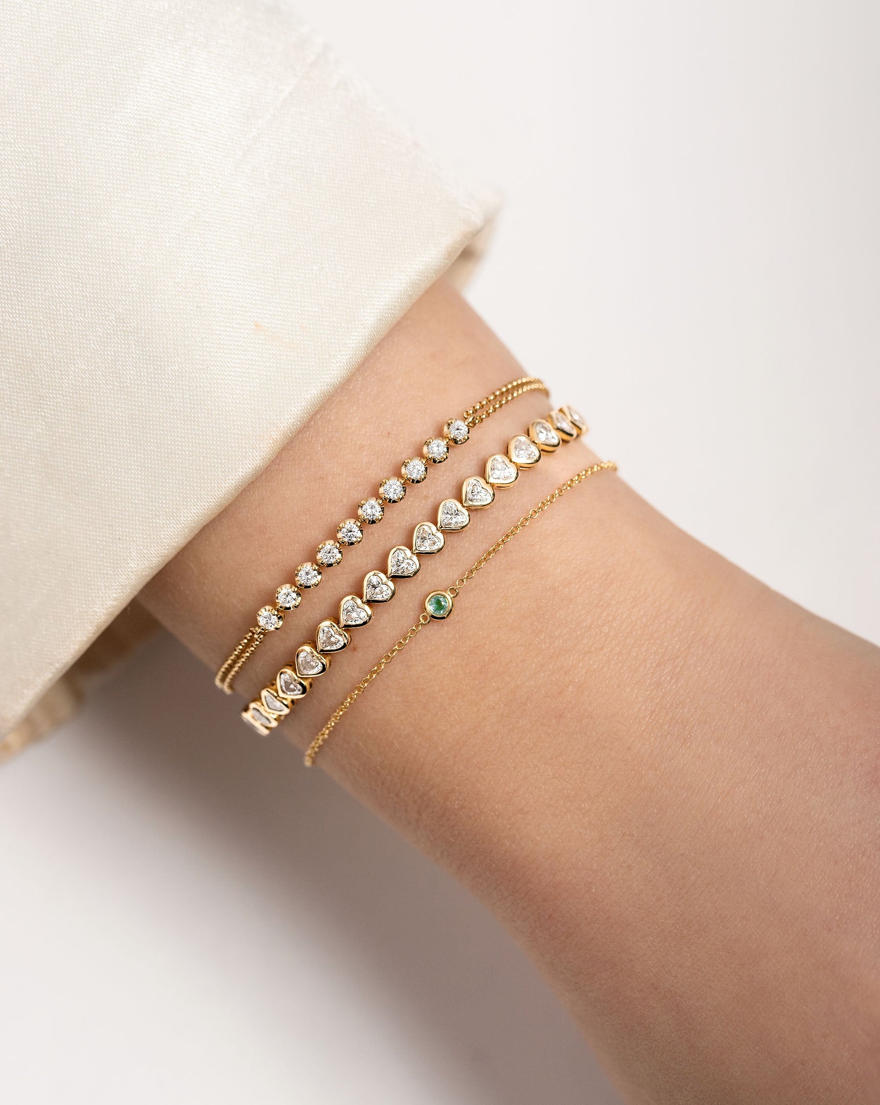 Gemstone Bezel-Set Bracelet, Double Chain Diamond Bracelet, and Heart Bezel Tennis Bracelet on model