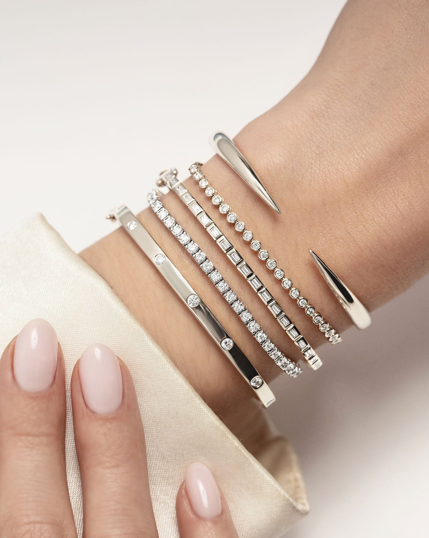 Baguette Bezel Bangle in white gold styled with other bracelets