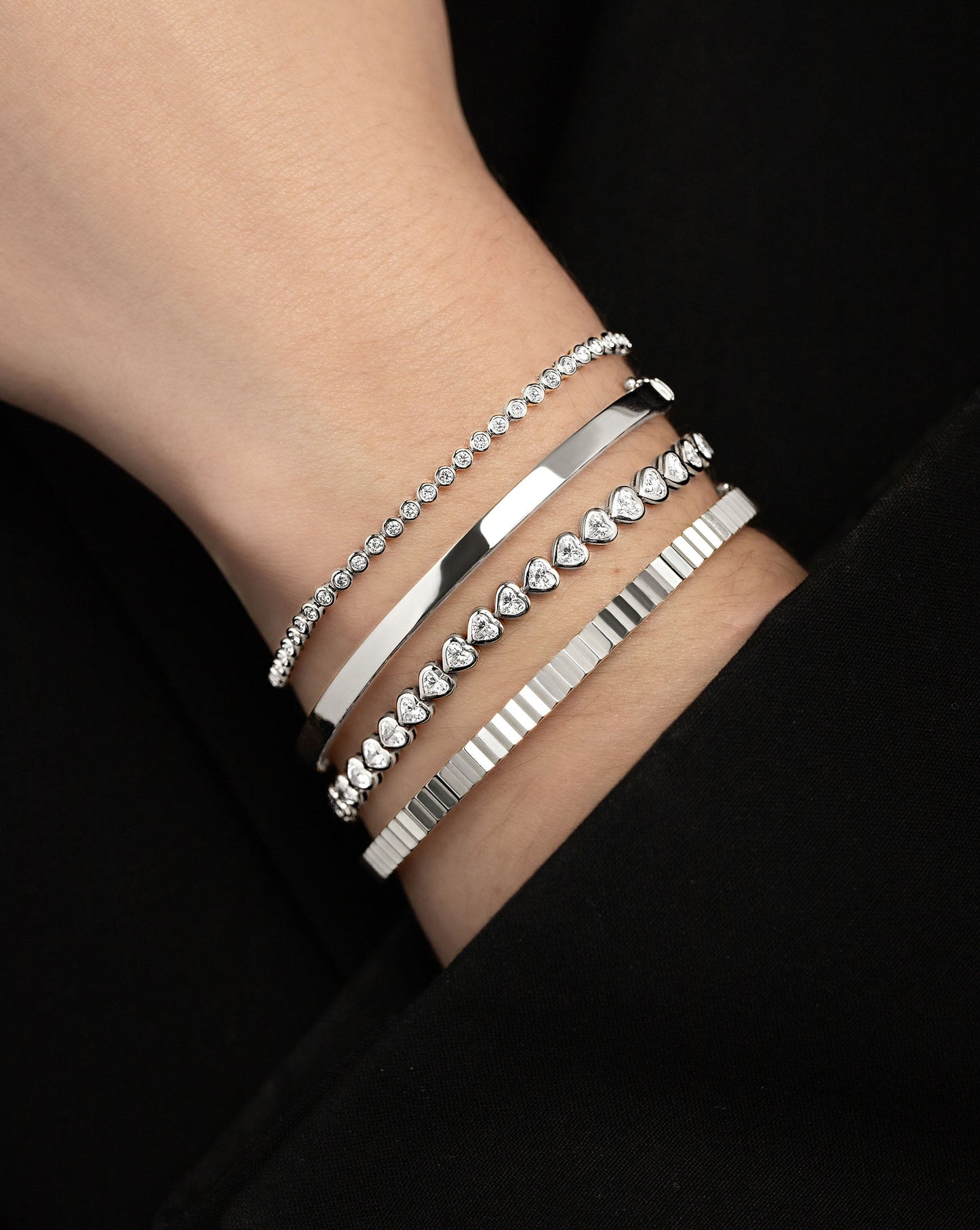 Stackable Gold Bangle in White gold styled with other diamond and gold bracelets