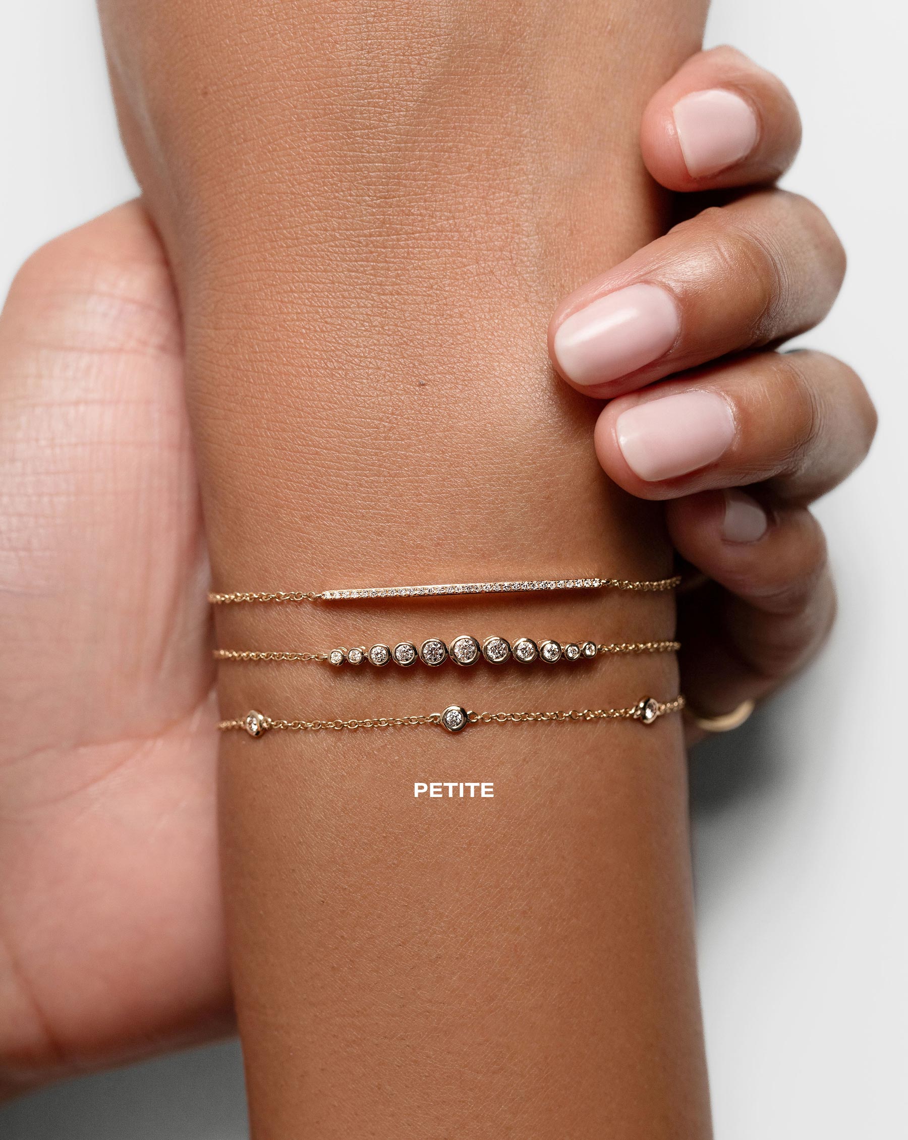 Petite Diamond Bezel-Set Station Bracelet shown on wrist with Graduated Diamond Bezel Soft Chain Bracelet and the Diamond Bar Bracelet