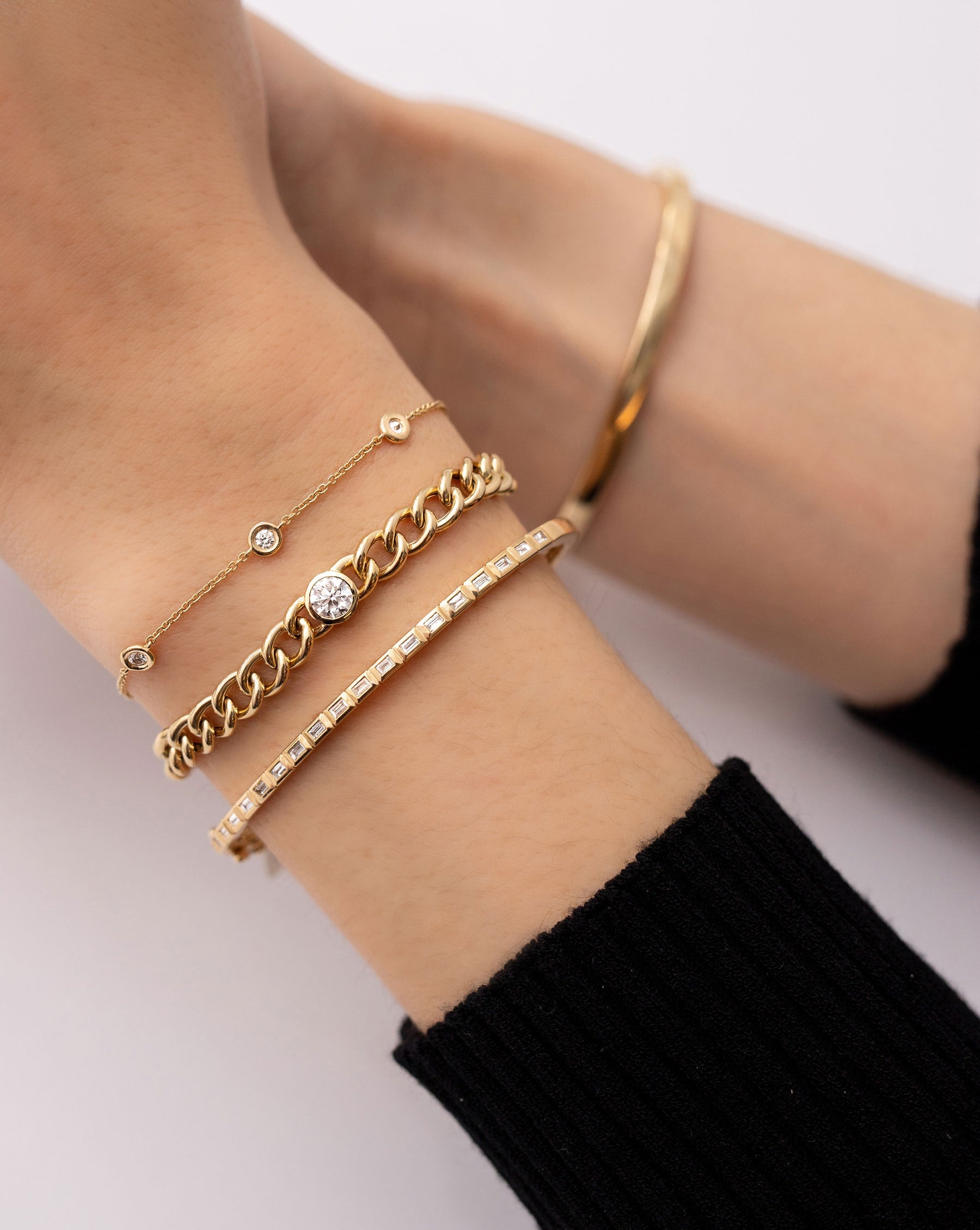 Ring Concierge 14k Yellow Gold Bezel-Set Diamond Curb Chain Bracelet, bezel-set diamond station bracelet and baguette diamond bangle on model