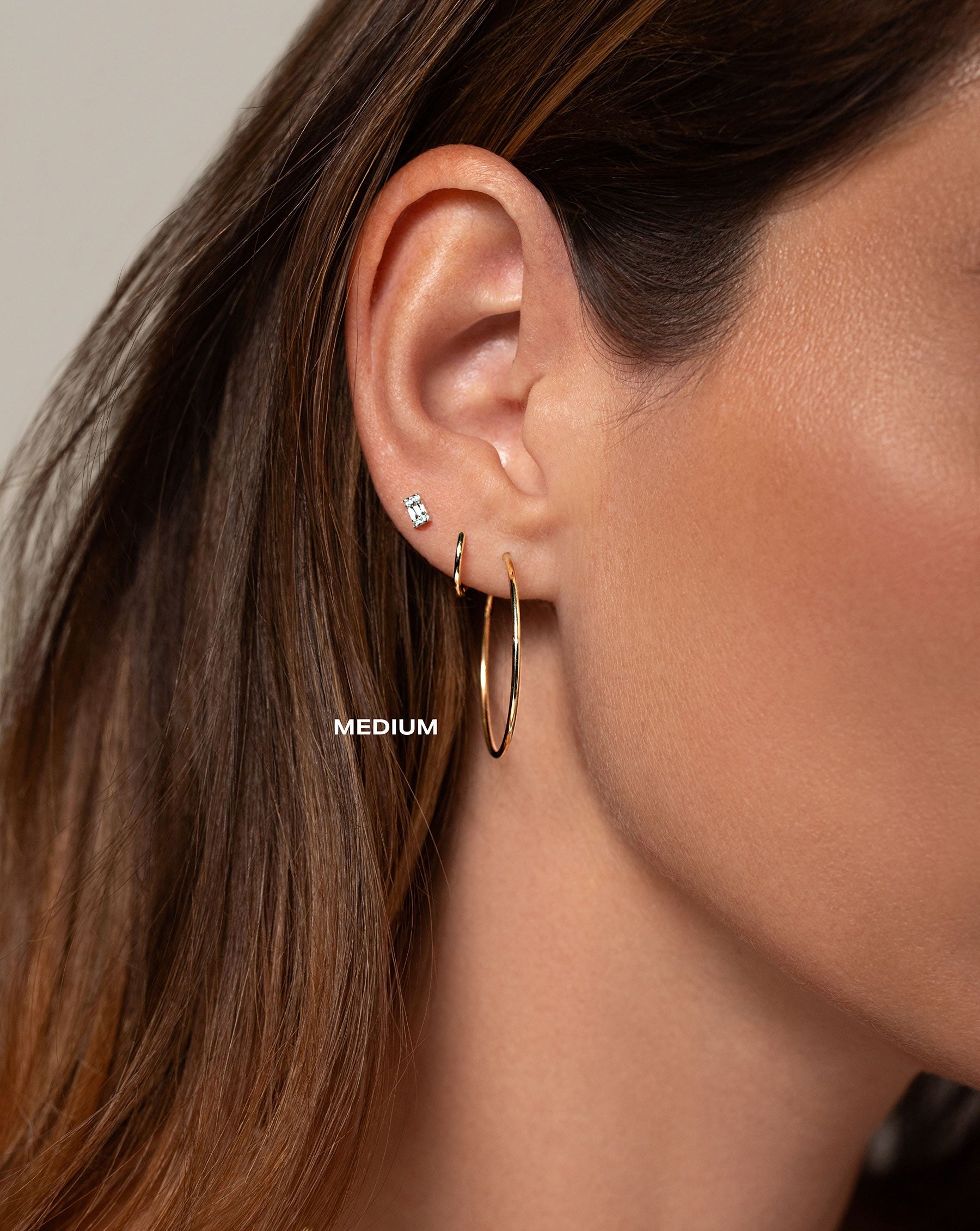 Size medium 1 mm Endless Gold Tube Hoops worn with the Mini Emerald Illusion Studs and the Classic Gold Ear Cuff