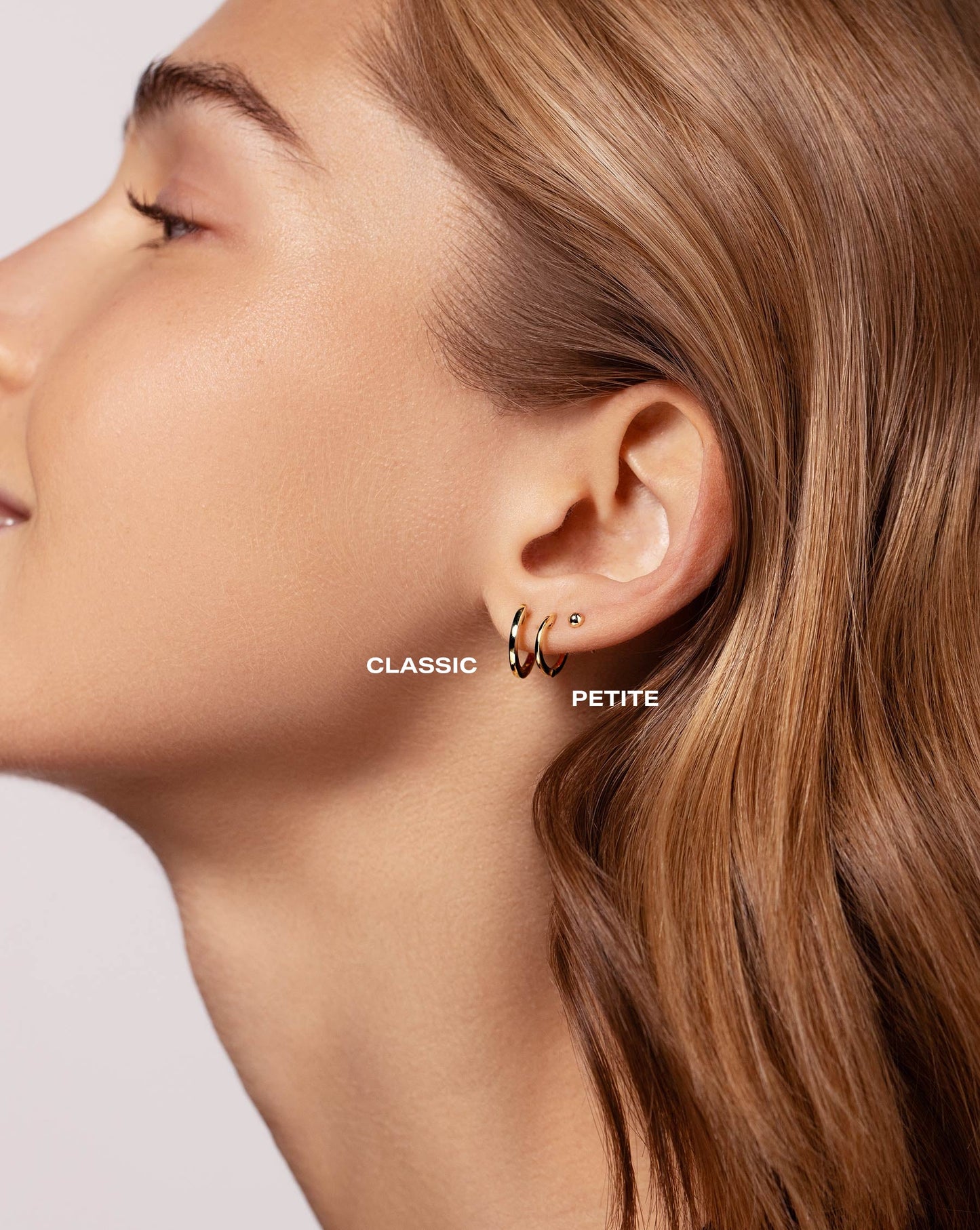 Classic Gold Huggies in both sizes worn with the Petite Gold Studs