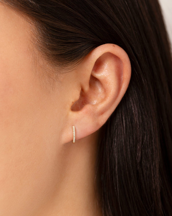 Petite Diamond Huggies shown alone on ear of model global