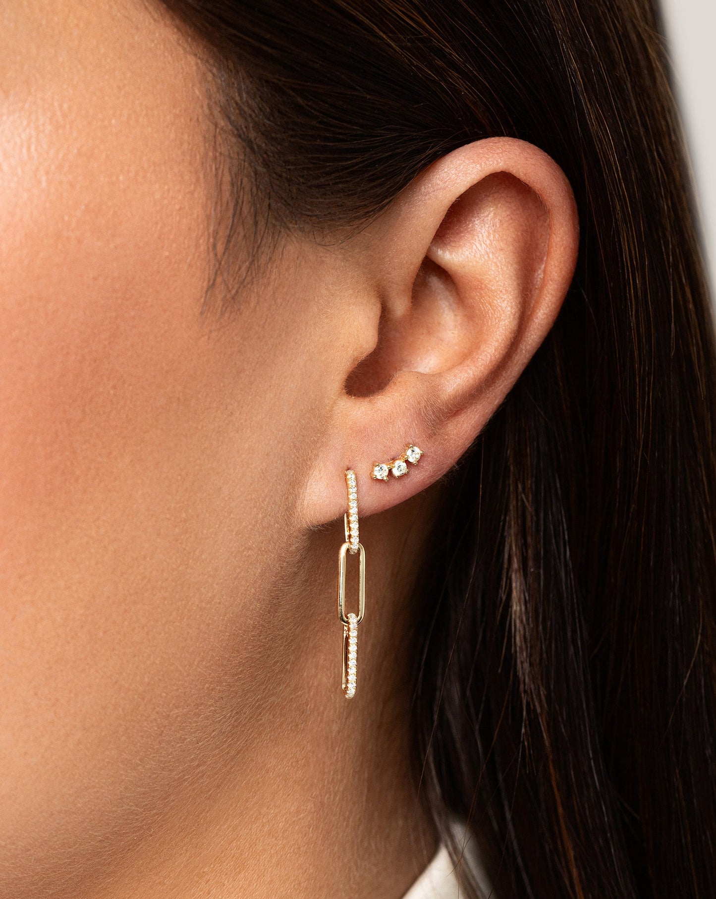 Curved Trio Studs on model styled with diamond link drop earrings