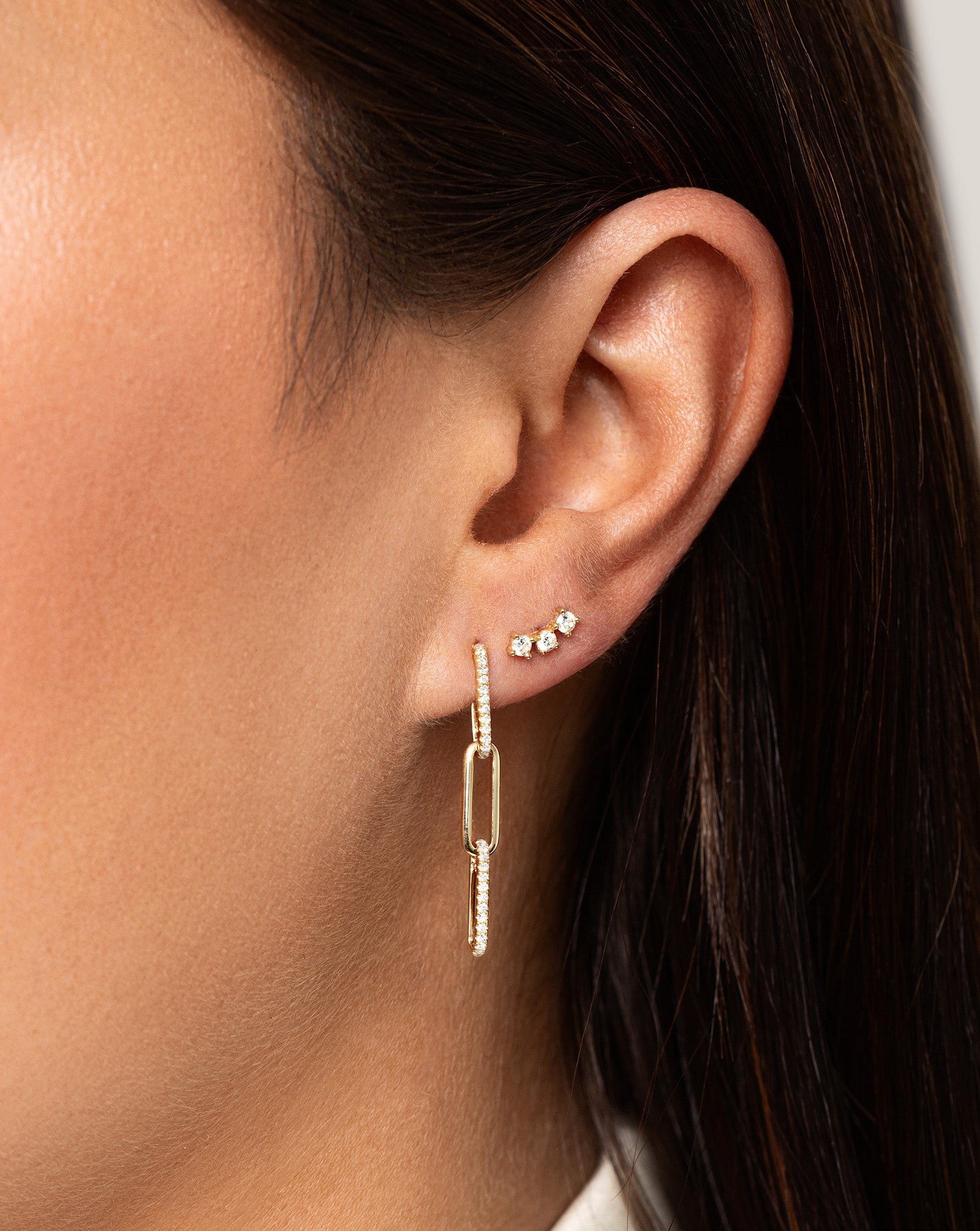 Curved Trio Studs on model styled with diamond link drop earrings