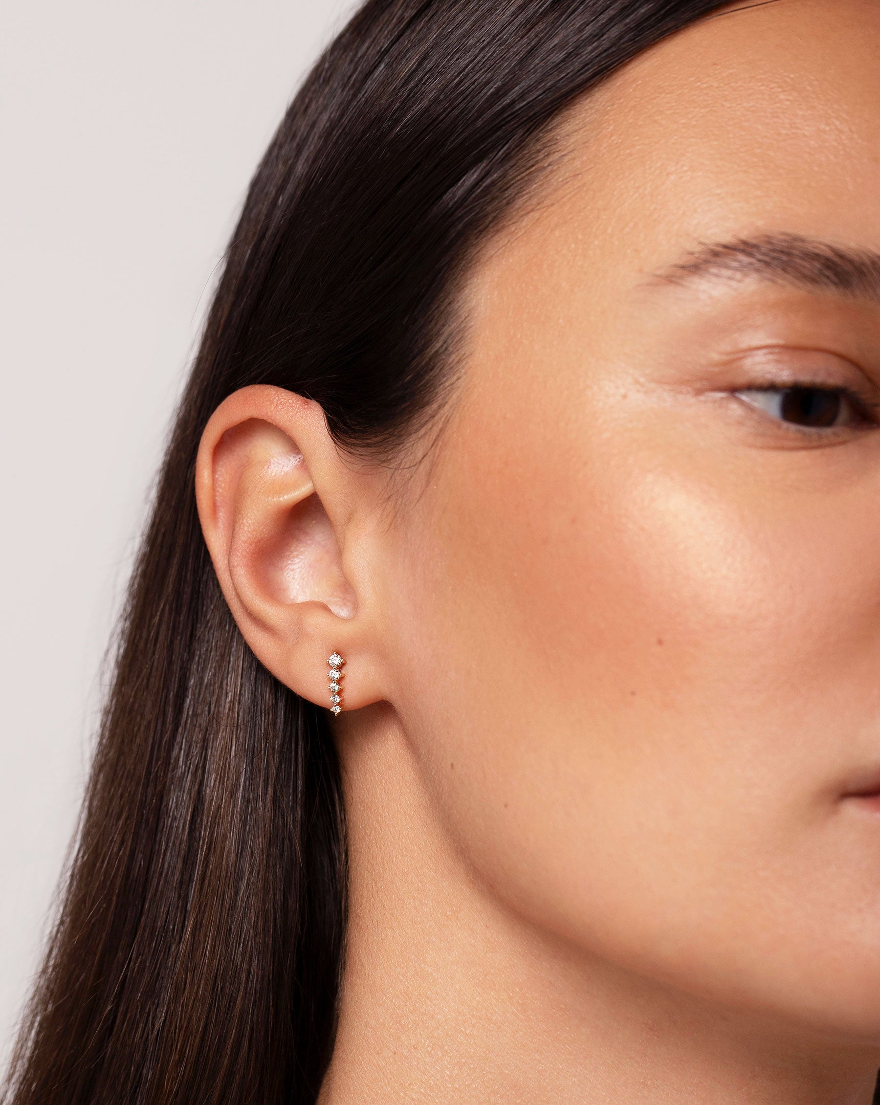 Graduated Curved Studs shown on ear of model