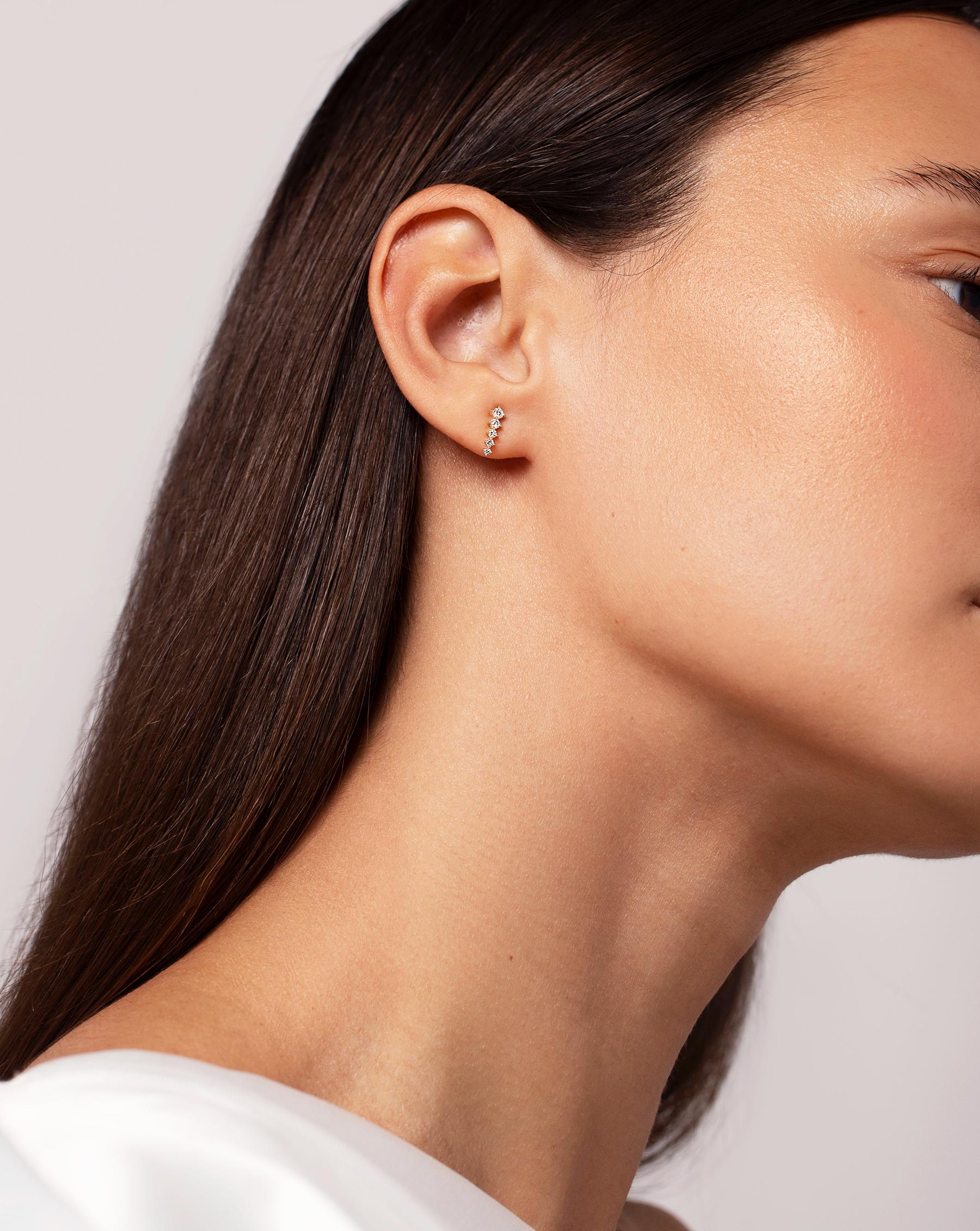 Graduated Curved Studs on ear of model with head slightly tilted away