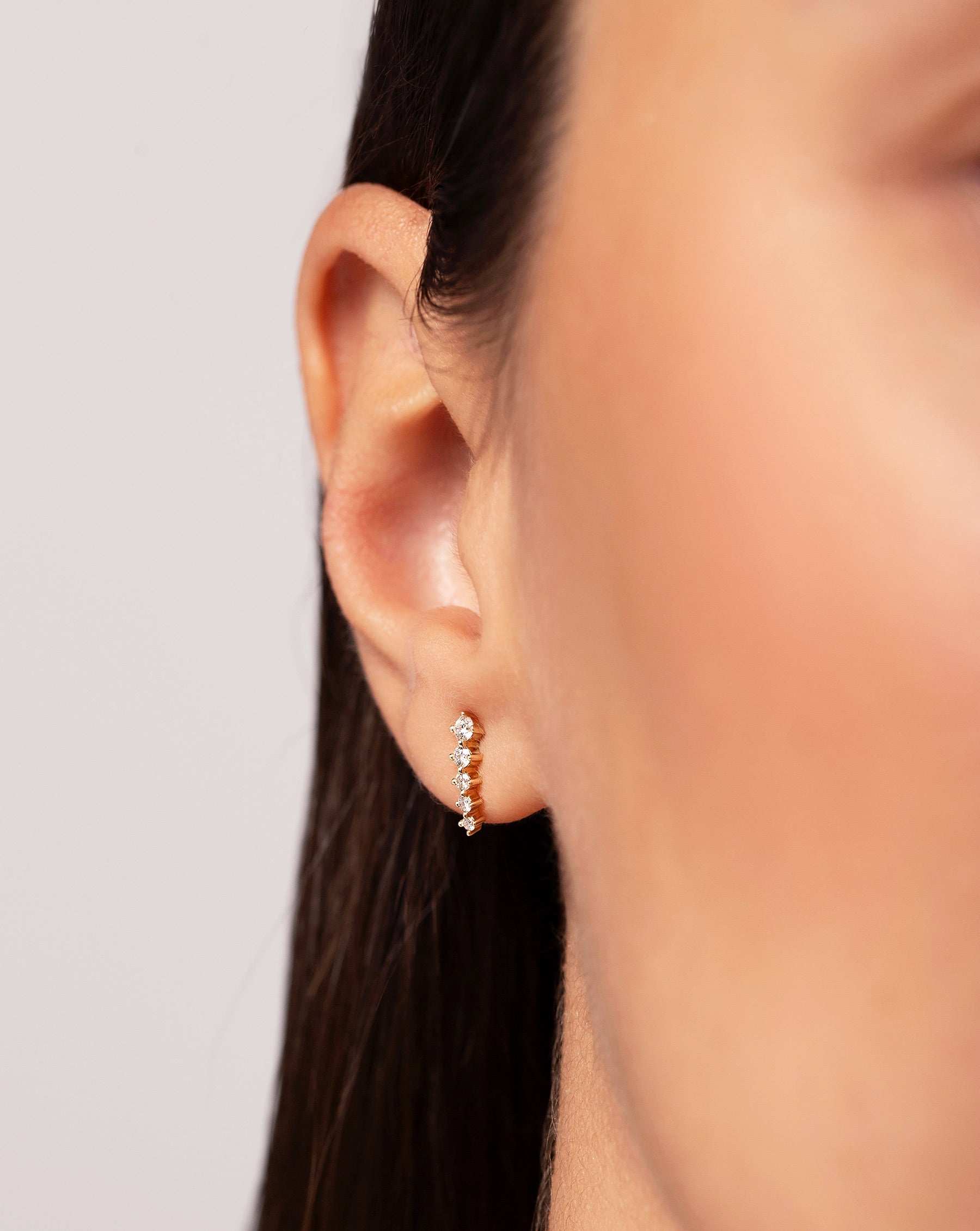 Close up image of the Graduated Curved Studs shown on ear