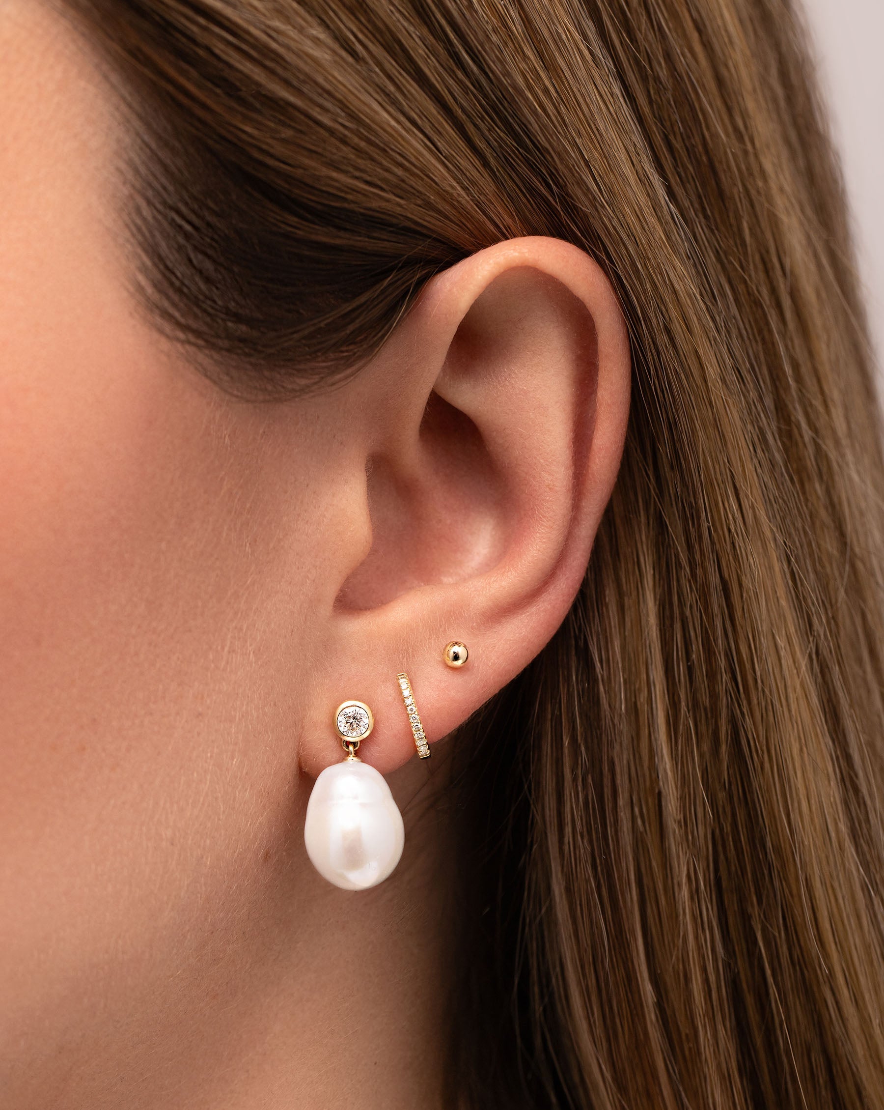 Organic Pearl + Diamond Earrings, Petite Diamond Huggies and Petite Gold Studs on model