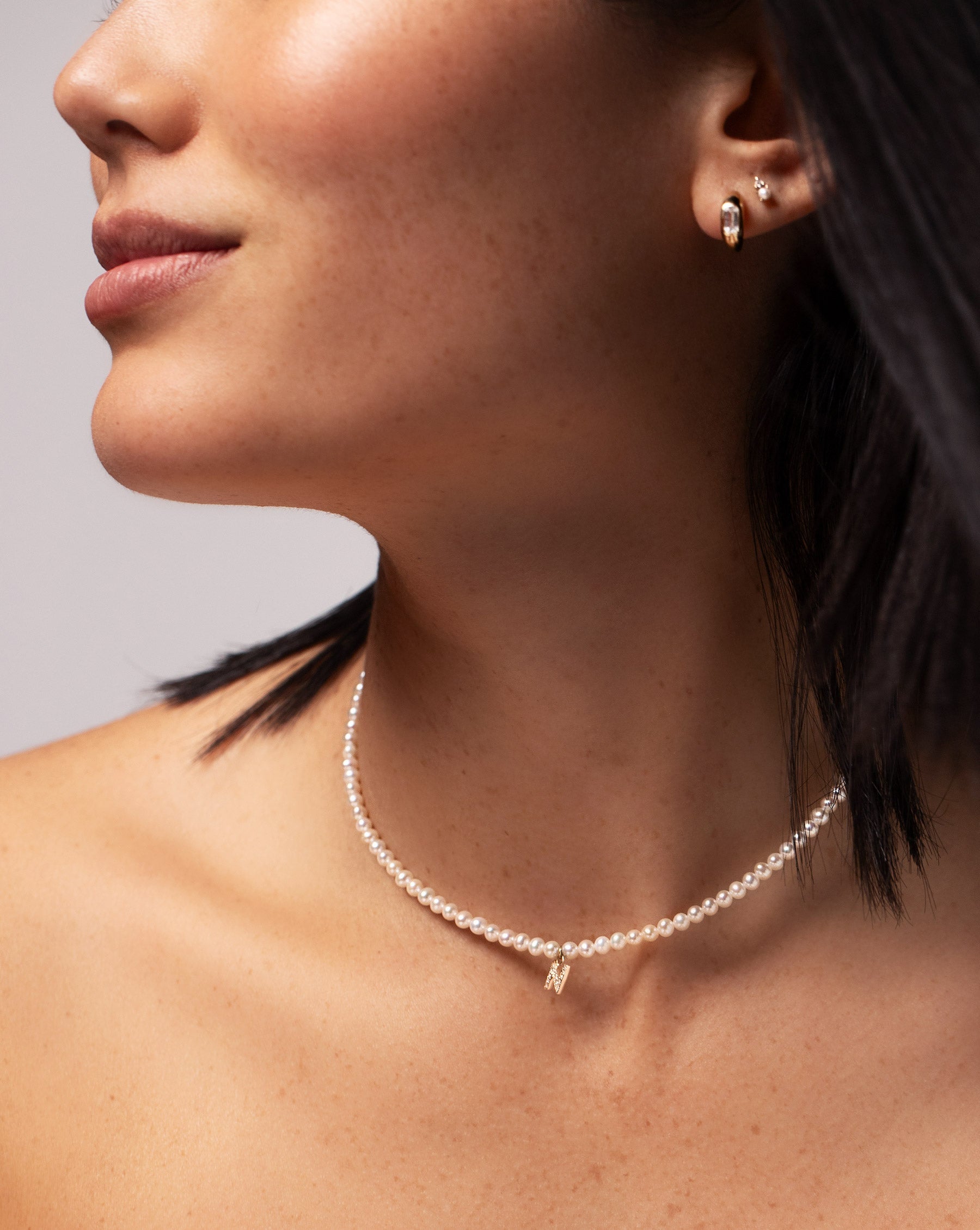 Pearl + Pavé Initial Choker shown on neck of model wearing the letter N