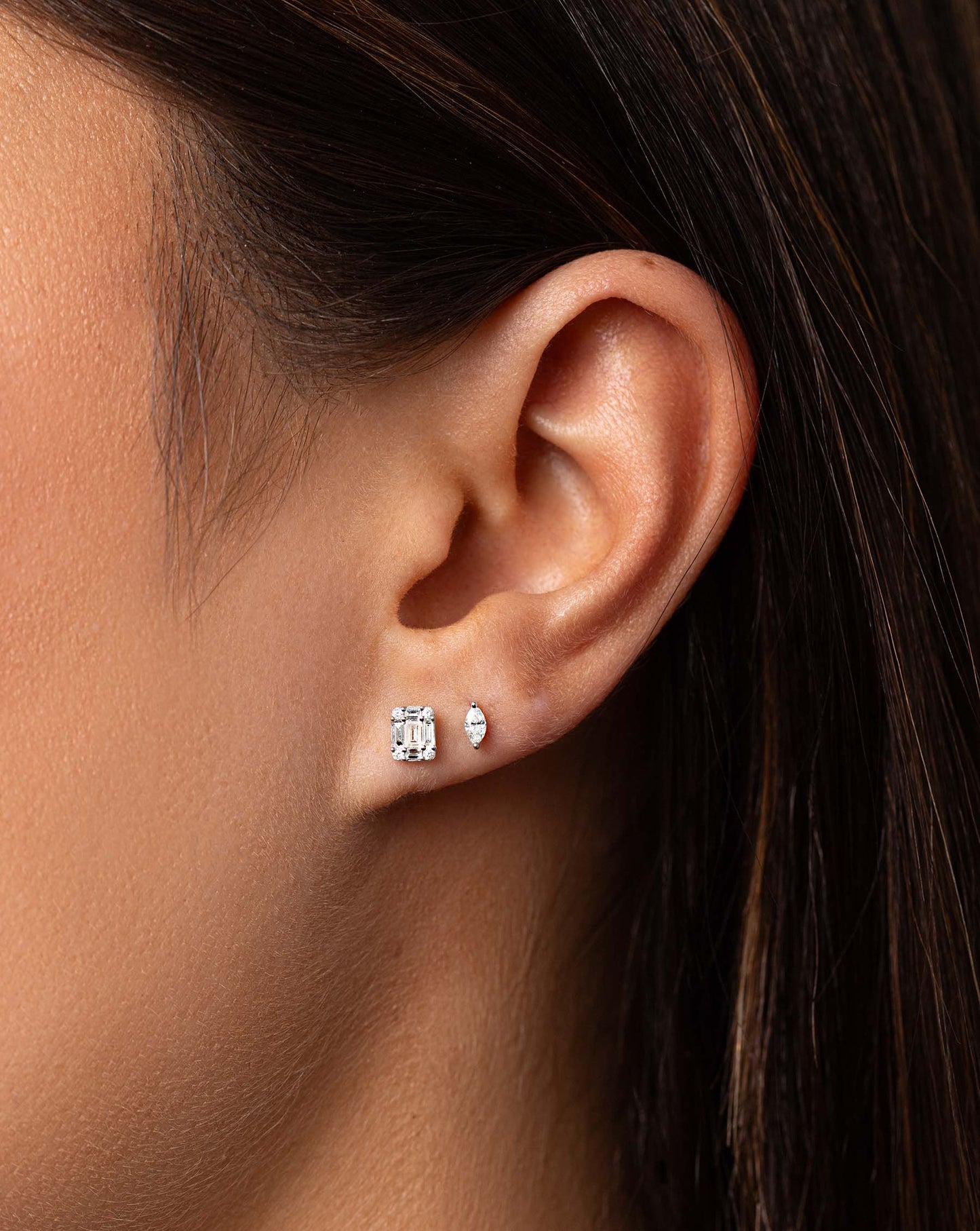 Petite Emerald Illusion Studs styled with tiny marquise studs on model