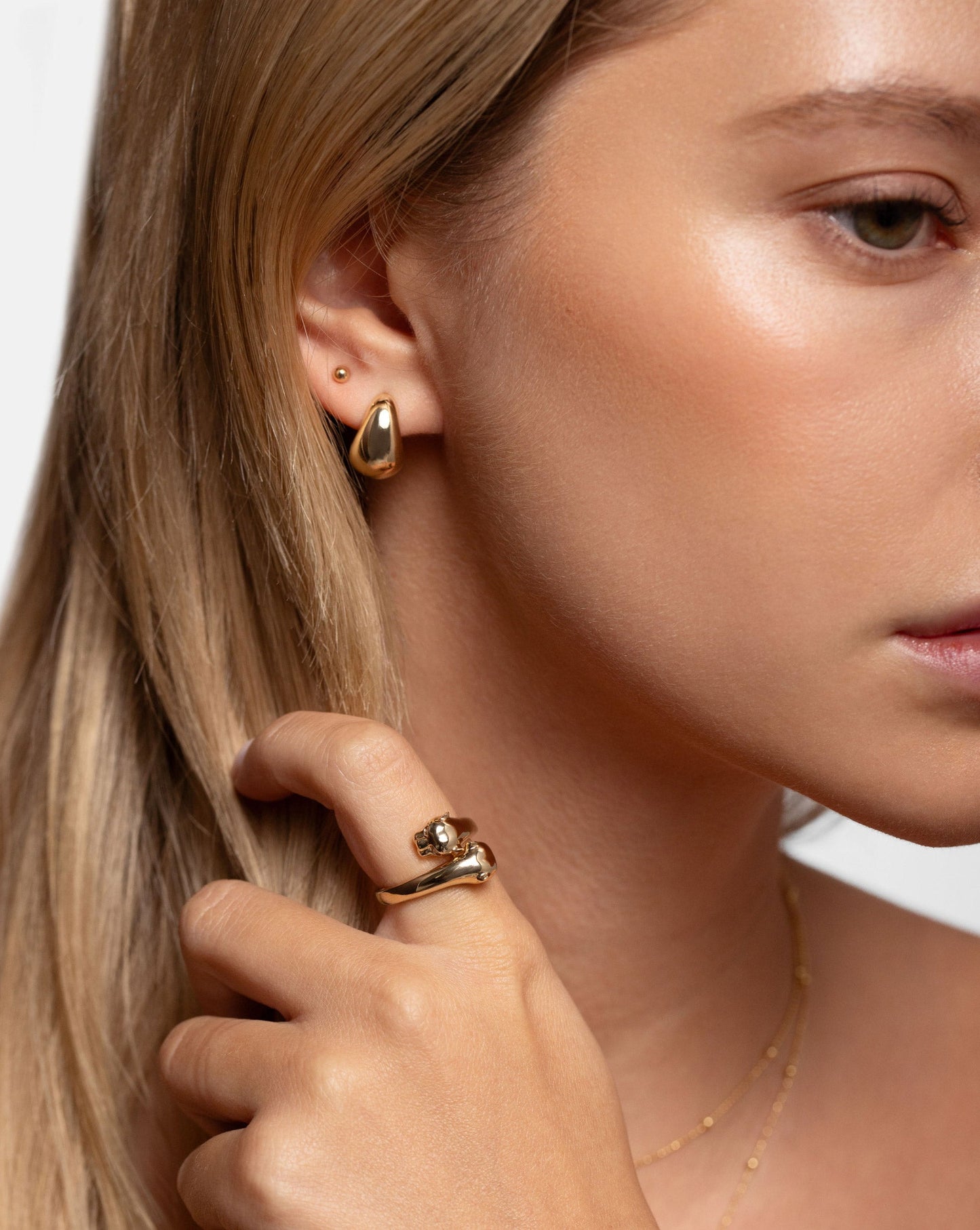 Ring Concierge Mini Gold Cloud Earrings 14k Yellow Gold - on-model styled with studs and hand near face with panther ring