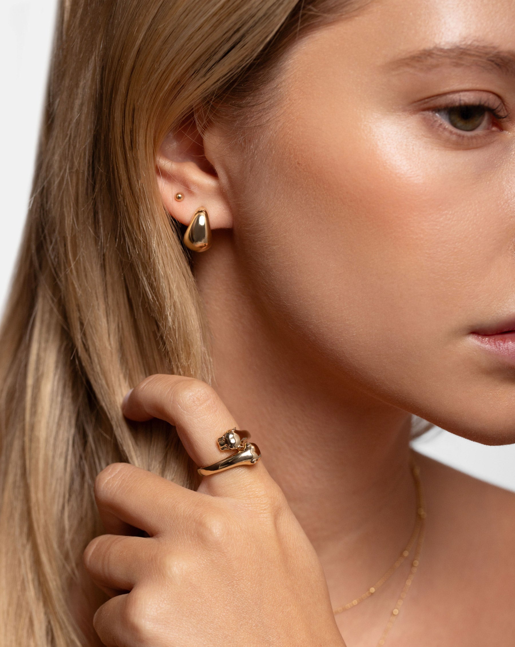 Ring Concierge Mini Gold Cloud Earrings 14k Yellow Gold - on-model styled with studs and hand near face with panther ring