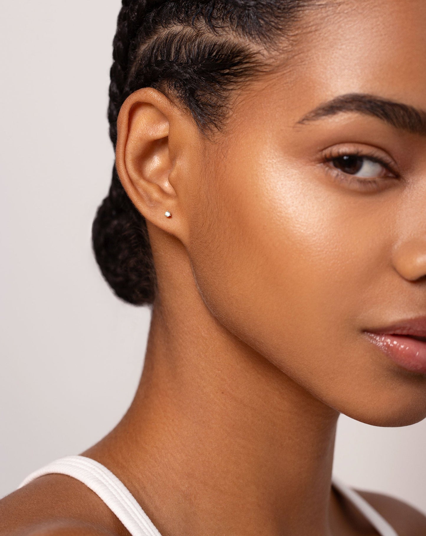 Tiny Diamond Studs shown by itself on ear of model 