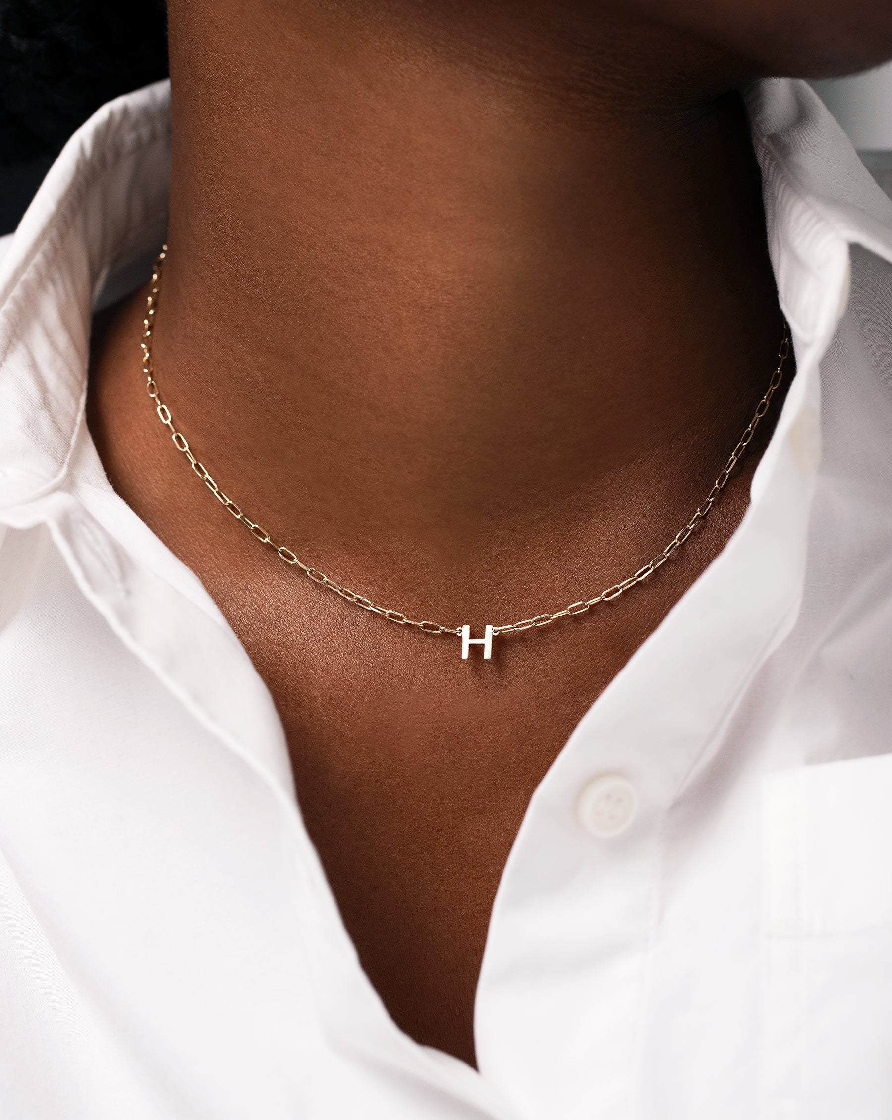 Block Initial + Link Chain Necklace with the letter H worn on model's neck