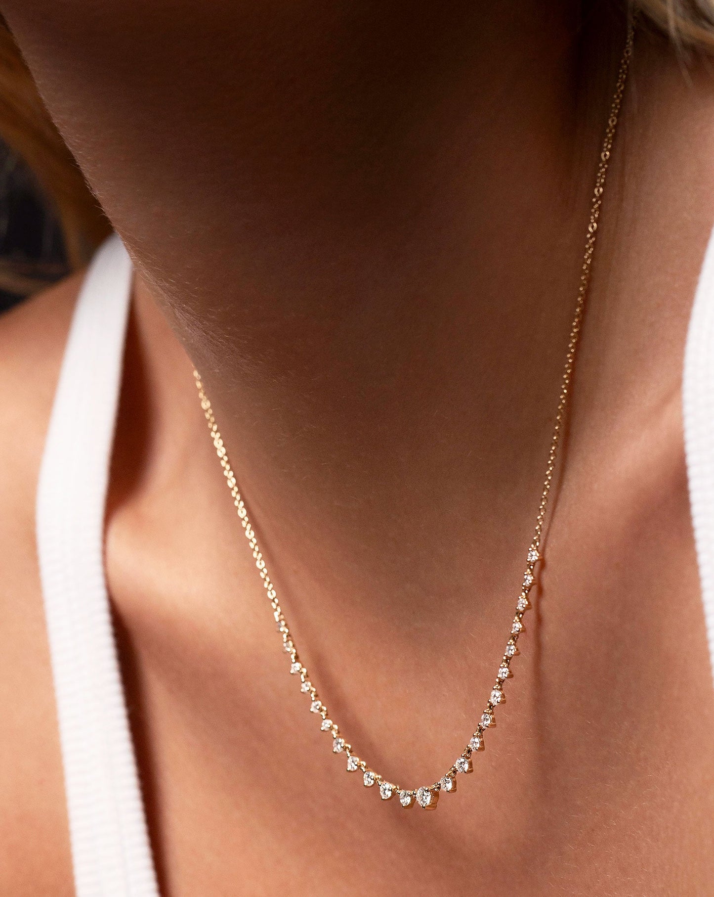 Close up image of the Graduated Diamond Layering Necklace worn on neck