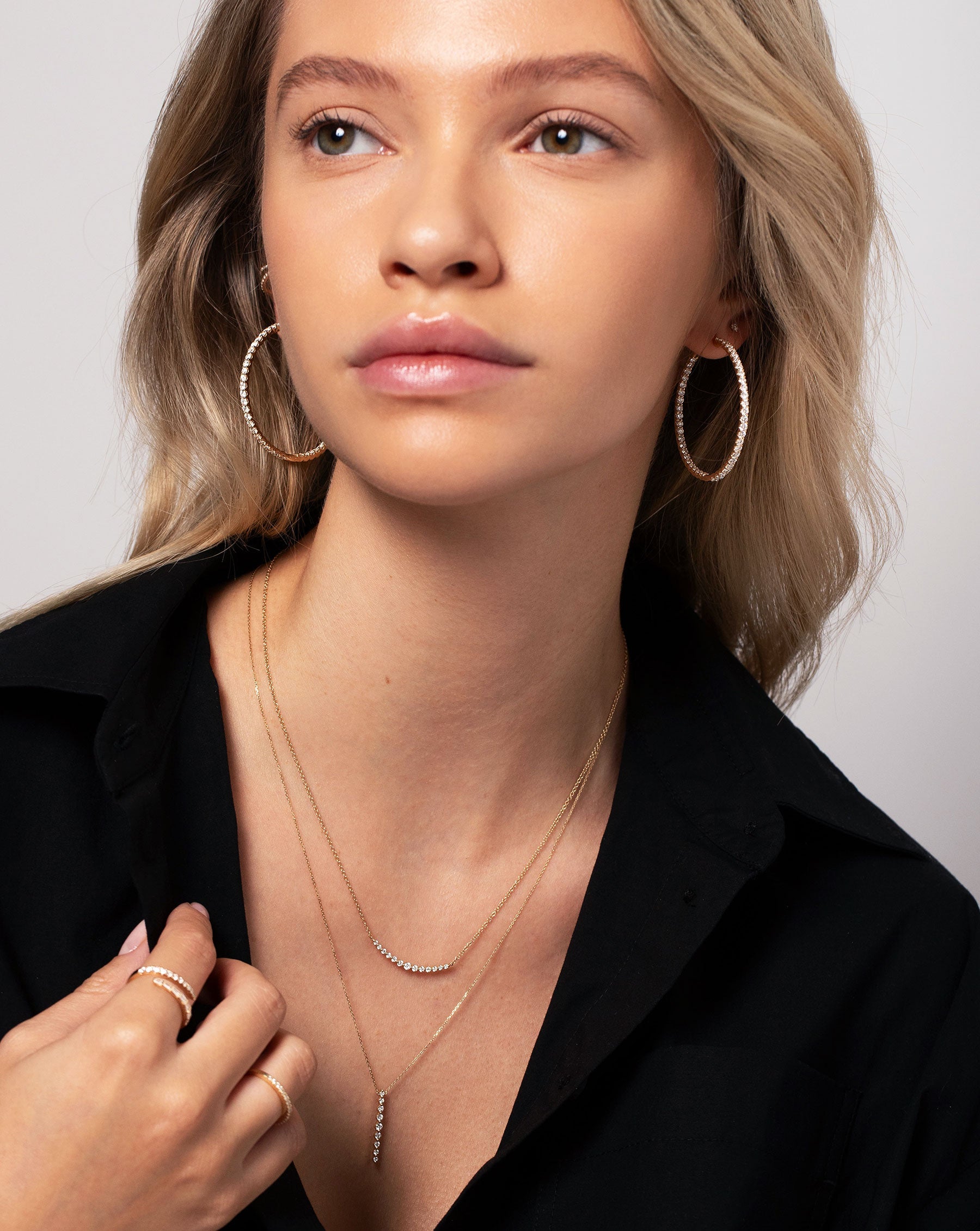 Vertical Graduated Single Prong Diamond Necklace worn with the Graduated Single Prong Diamond Necklace, Diamond Eternity Hoops, Luxe Open Diamond Wrap Ring and Stackable Pave Diamond Ring