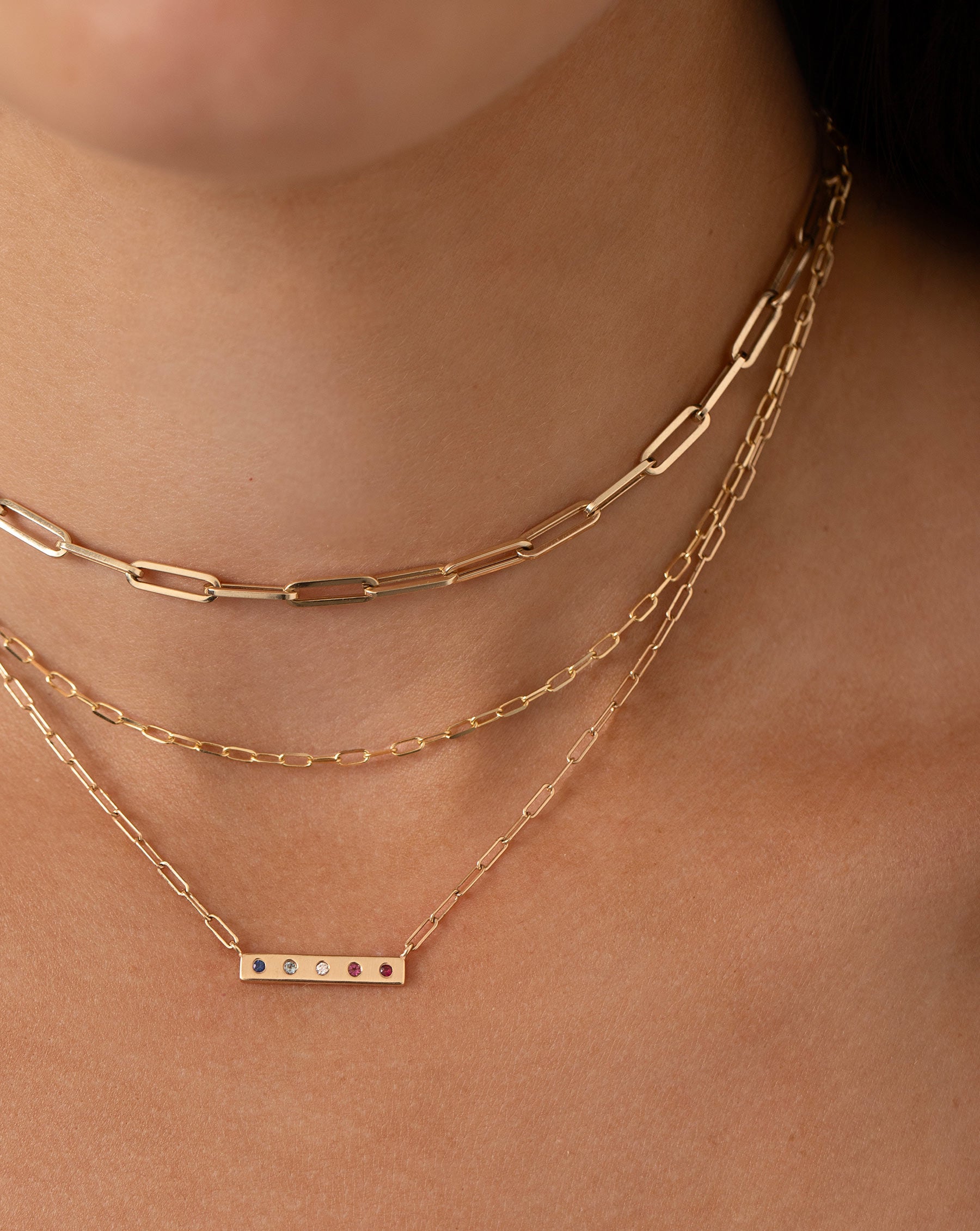 5 inlay birthstone bar necklace, mini gold link necklace, and large gold link necklace shown on model