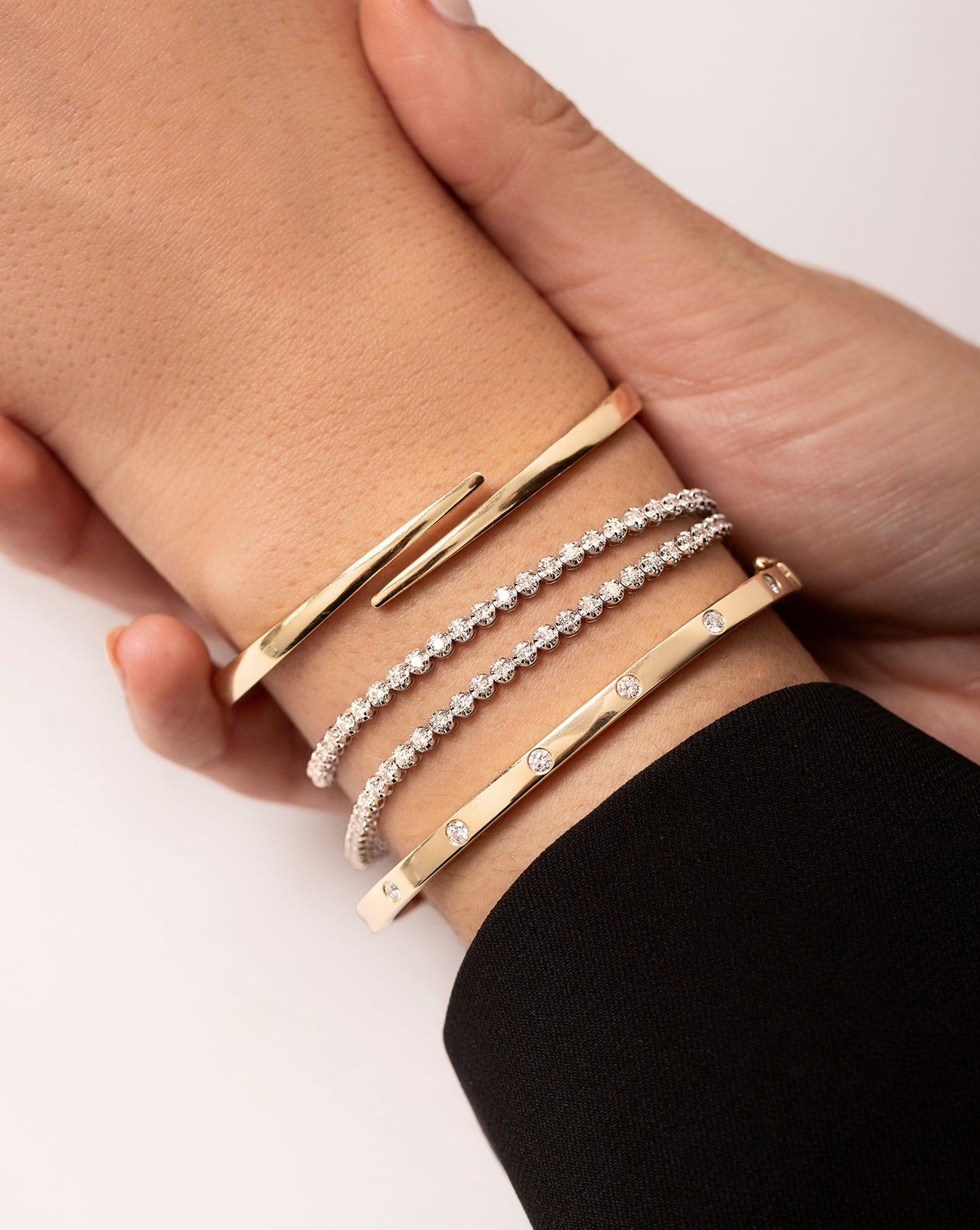 Multiway Tennis Necklace + Double Wrap Bracelet shown on wrist with the Inlay Diamond Bangle and Open Wrap Gold Bangle