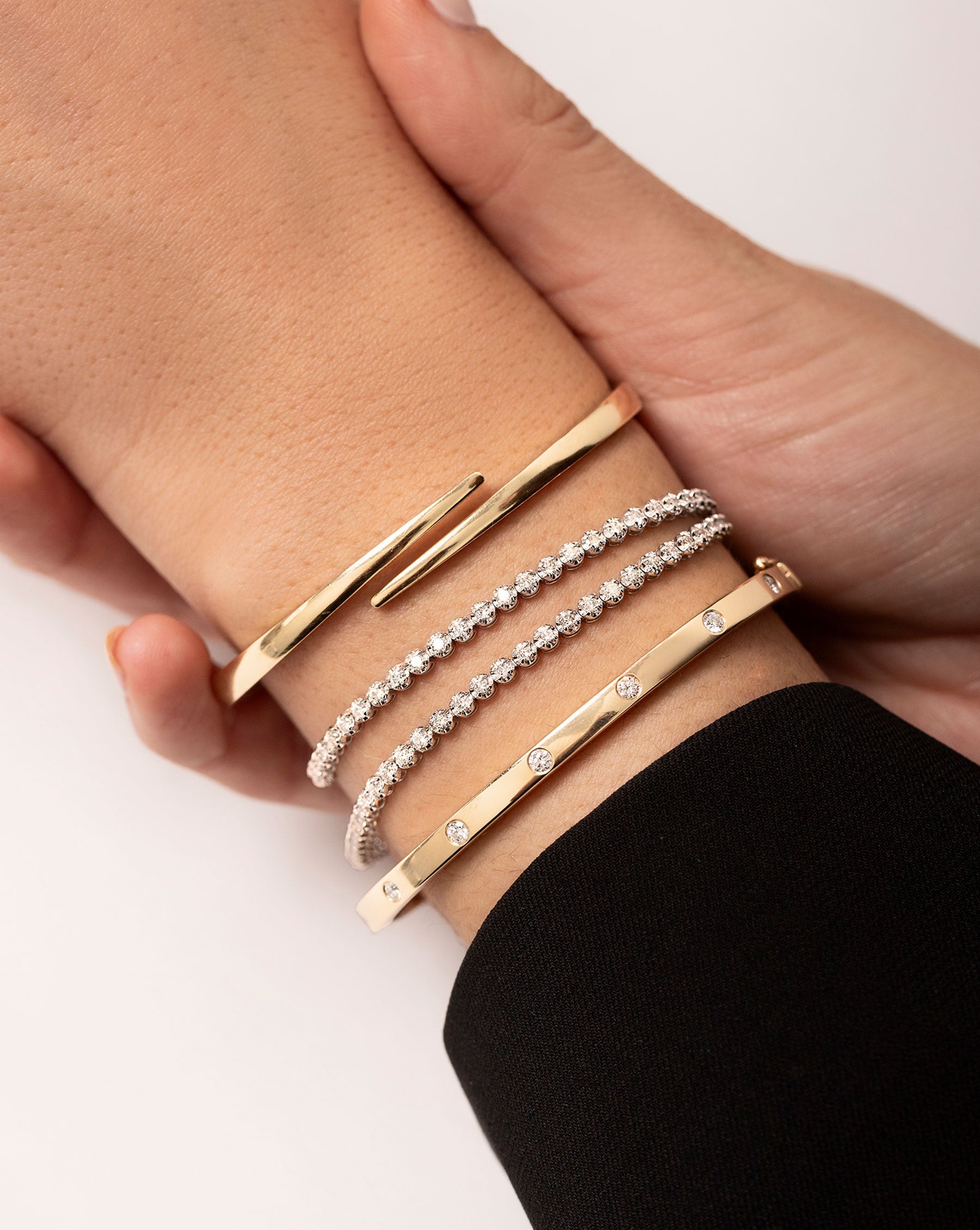 Multiway Tennis Necklace + Double Wrap Bracelet shown on wrist with the Inlay Diamond Bangle and Open Wrap Gold Bangle