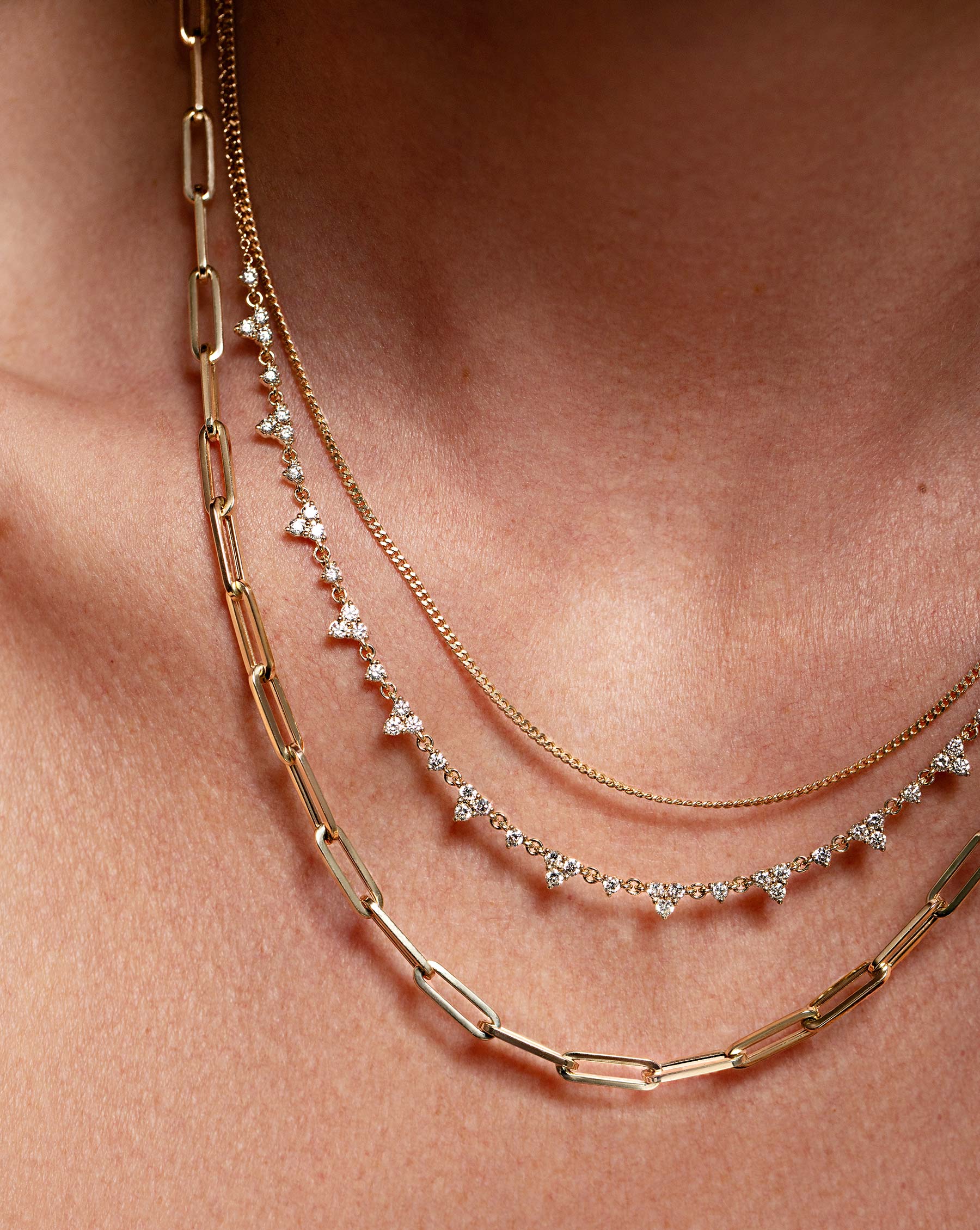 Close up of the Trio Diamond Layering Necklace worn with the Mulitway Jumbo Link Necklace + Double Wrap Bracelet with the Diamond Cut Curb Chain Necklace.