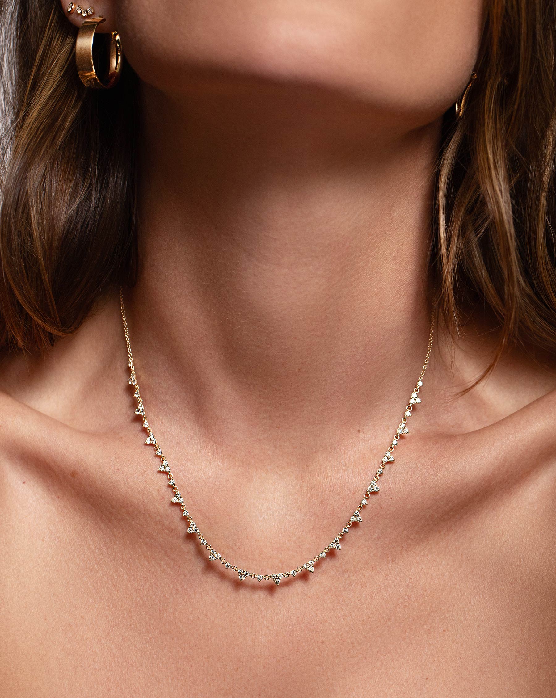 Trio Diamond Layering Necklace worn on neck of model styled with the Bold Gold Flat Hoops in model's ear