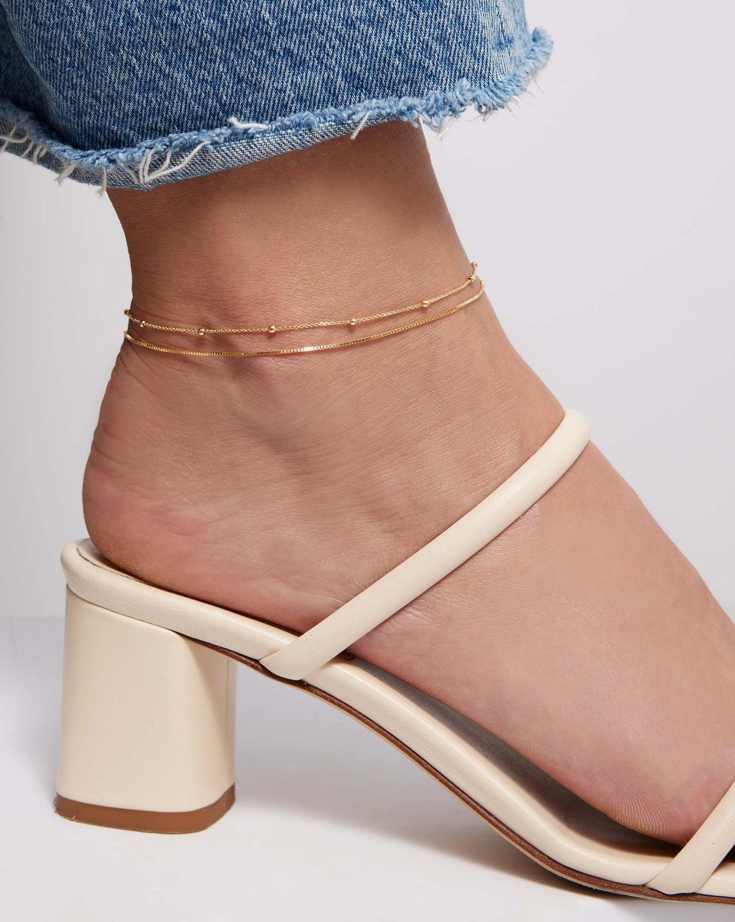 Saturn Chain Anklet layered with Petite Box Chain Anklet on model wearing block heel sandal