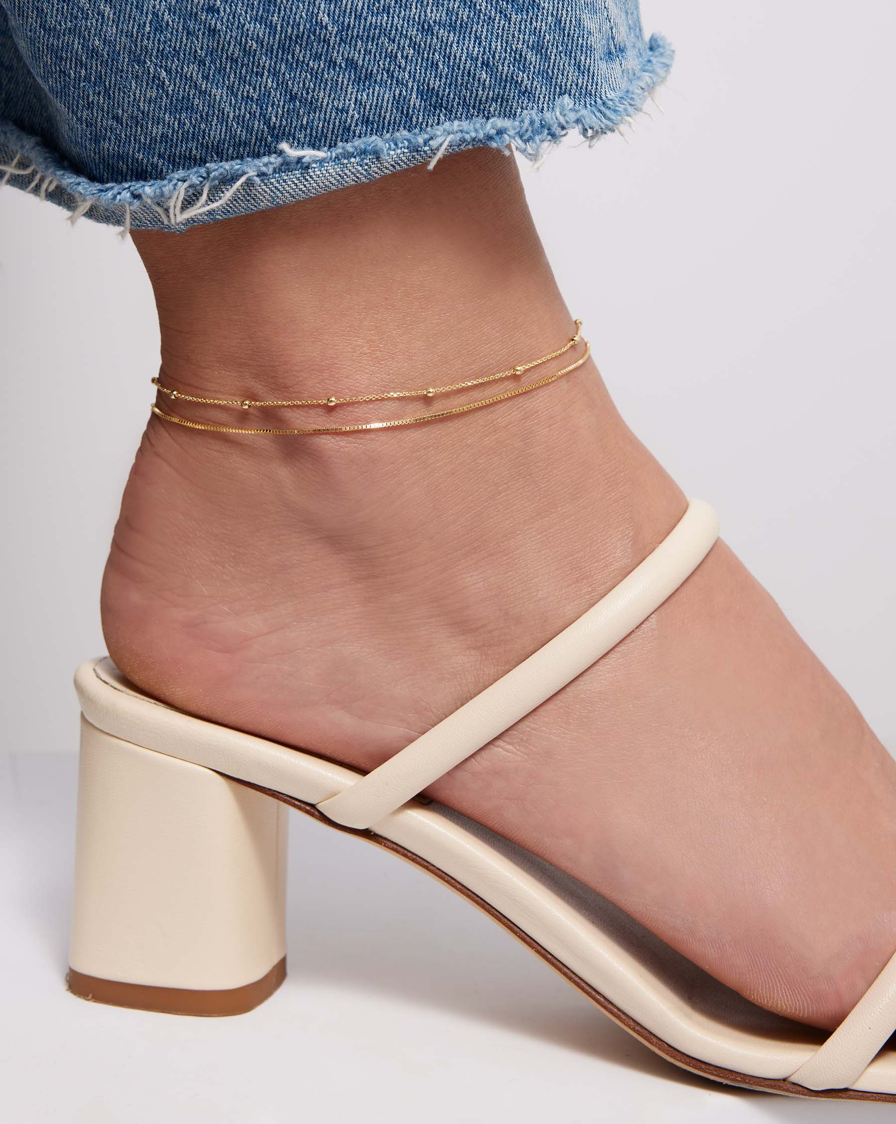 Saturn Chain Anklet layered with Petite Box Chain Anklet on model wearing block heel sandal