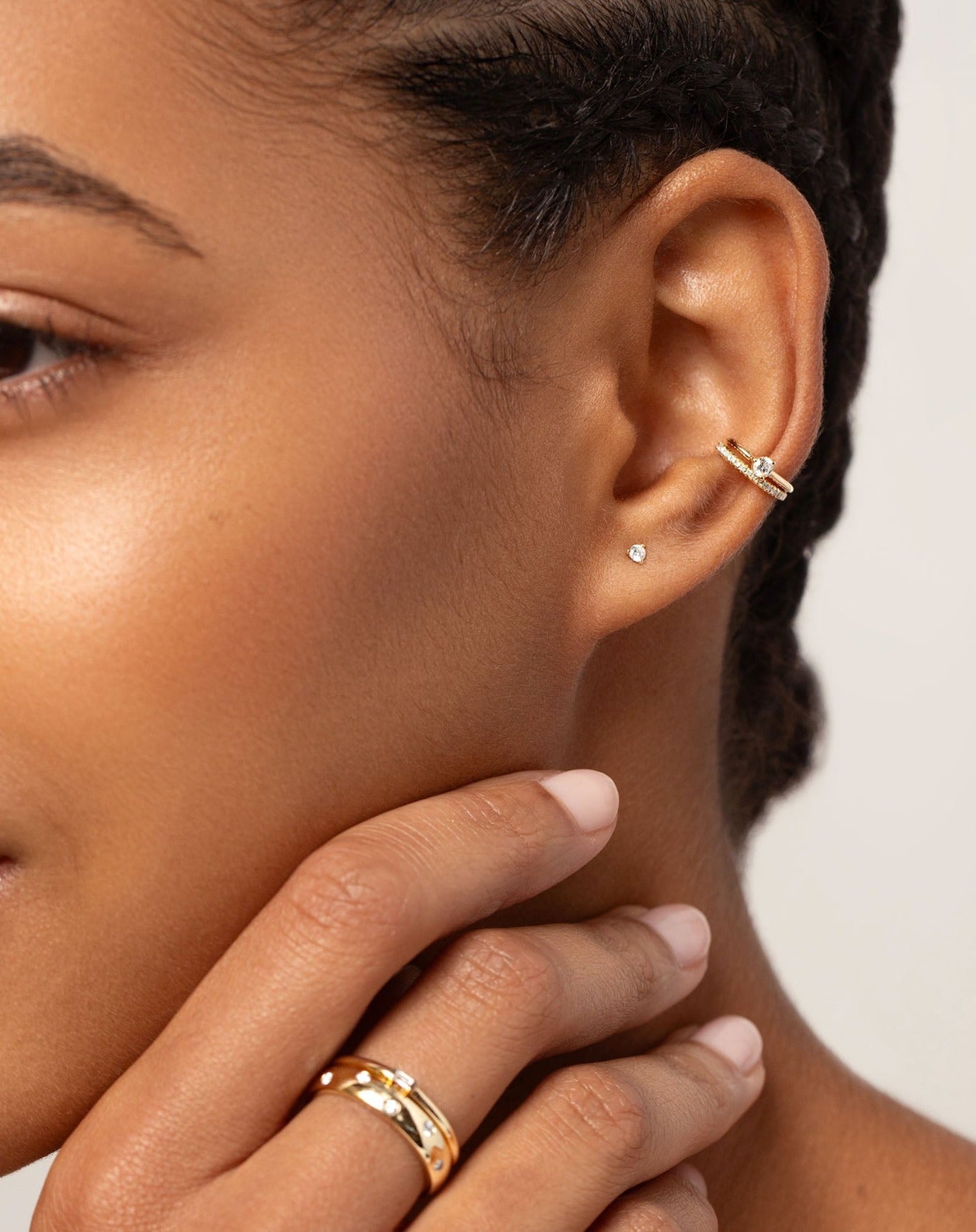 Diamond Ear Cuff stacked with single diamond ear cuff and tiny diamond studs on model